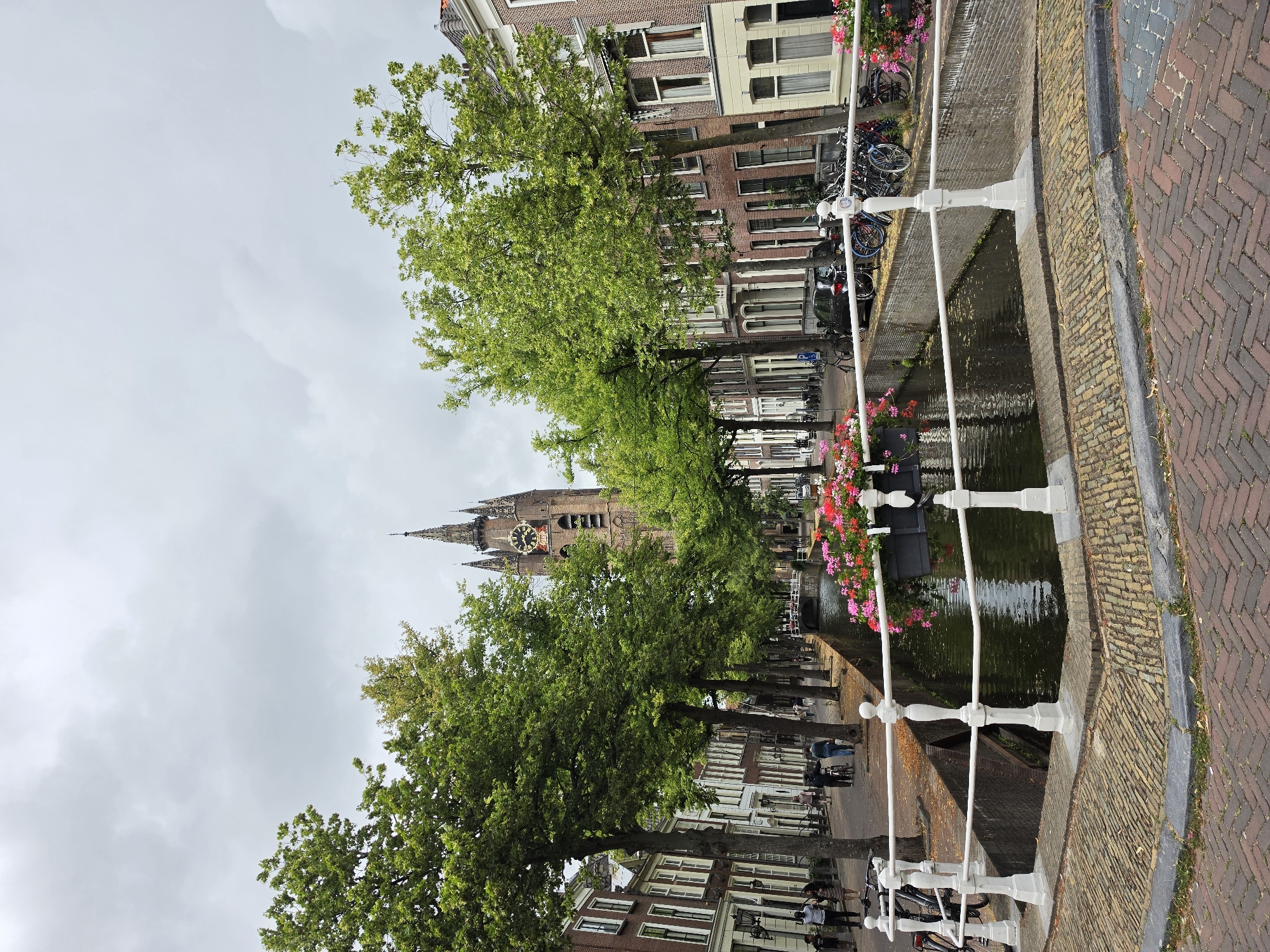 Canals, flowers, and historic stonework in central Delft