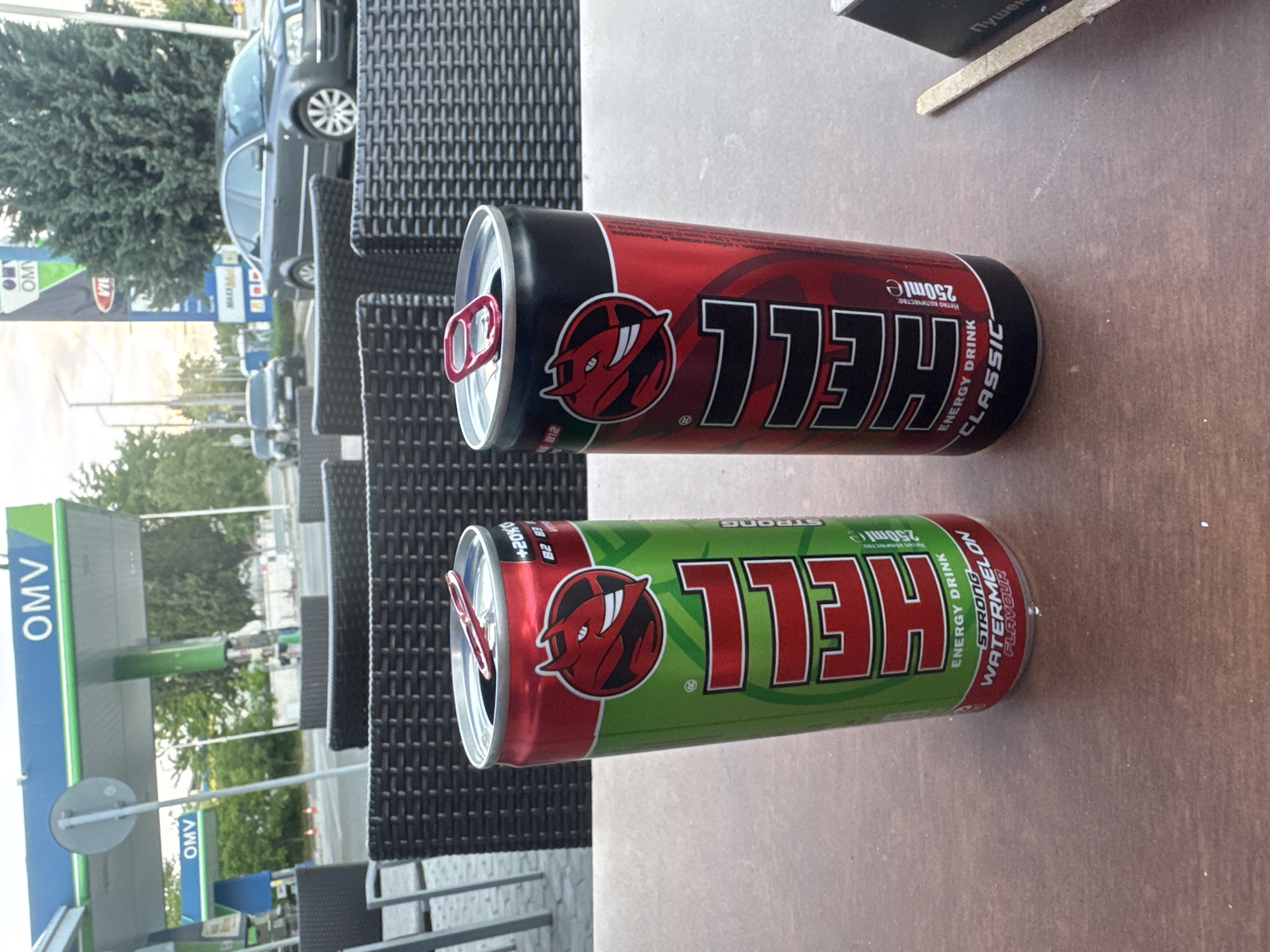 Person enjoys energy drinks at Bulgarian café near gas station