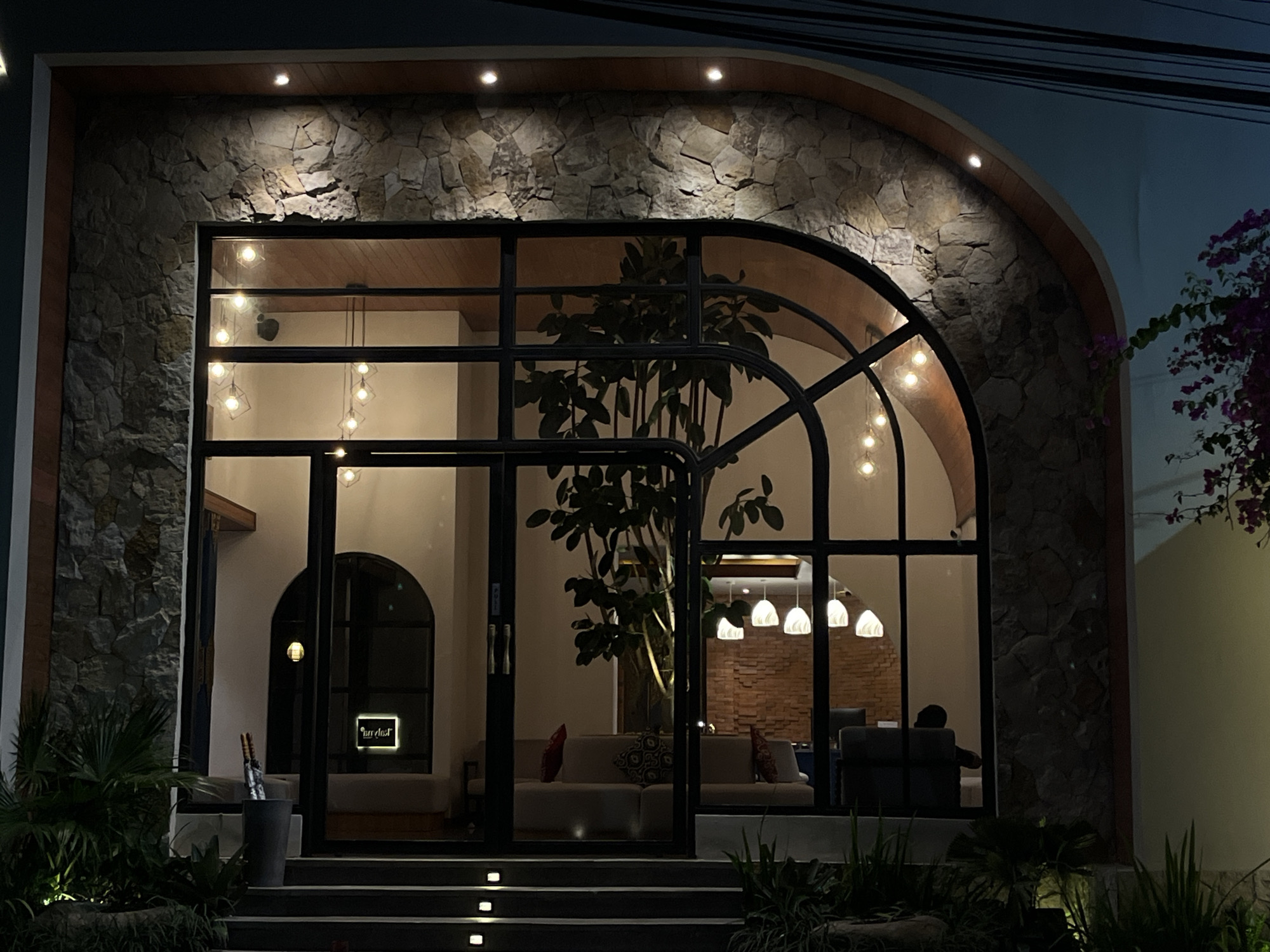 Modern glass building photographed at night in North Kuta