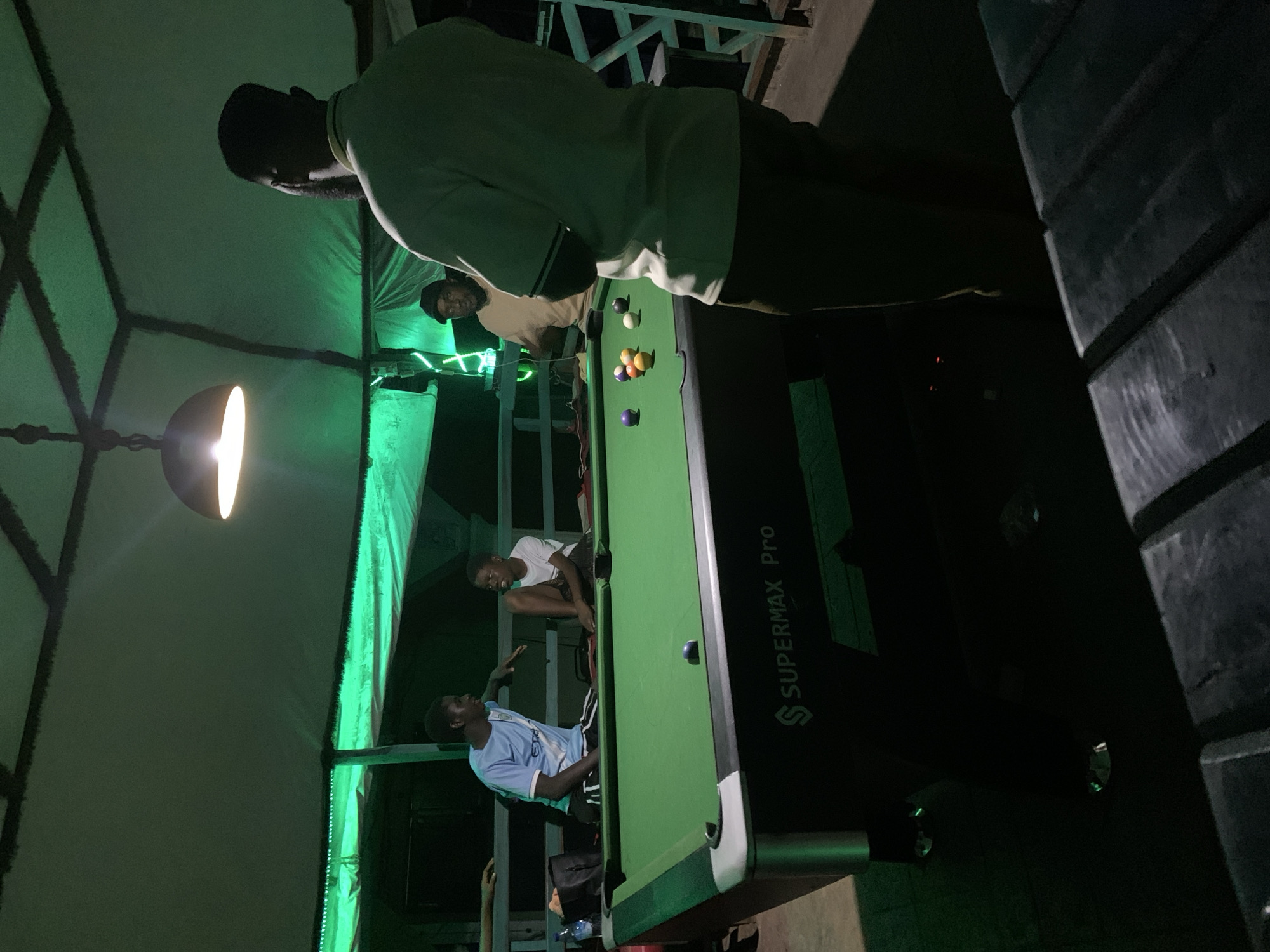 Outdoor billiards under neon lights in Lokoja at night