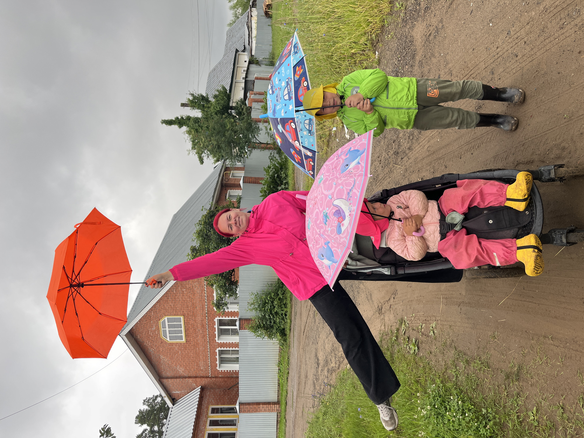 Overcast morning in Chaikovsky, colorful jackets and an orange umbrella