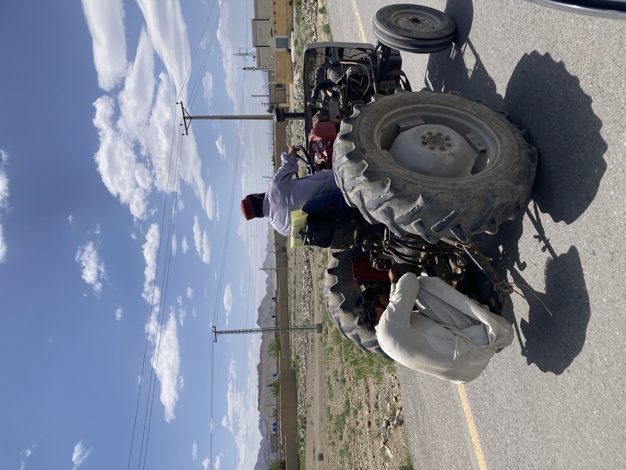 Man drives tractor on road in Qilla Saifullah, Pakistan