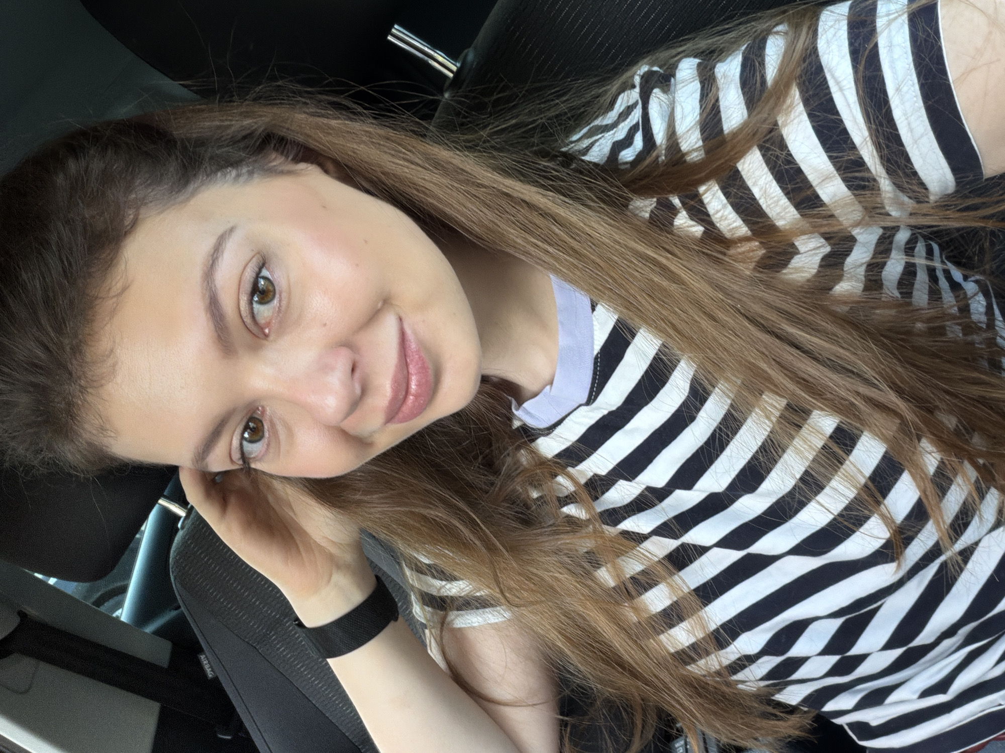 Woman exits car on sunny Moscow morning