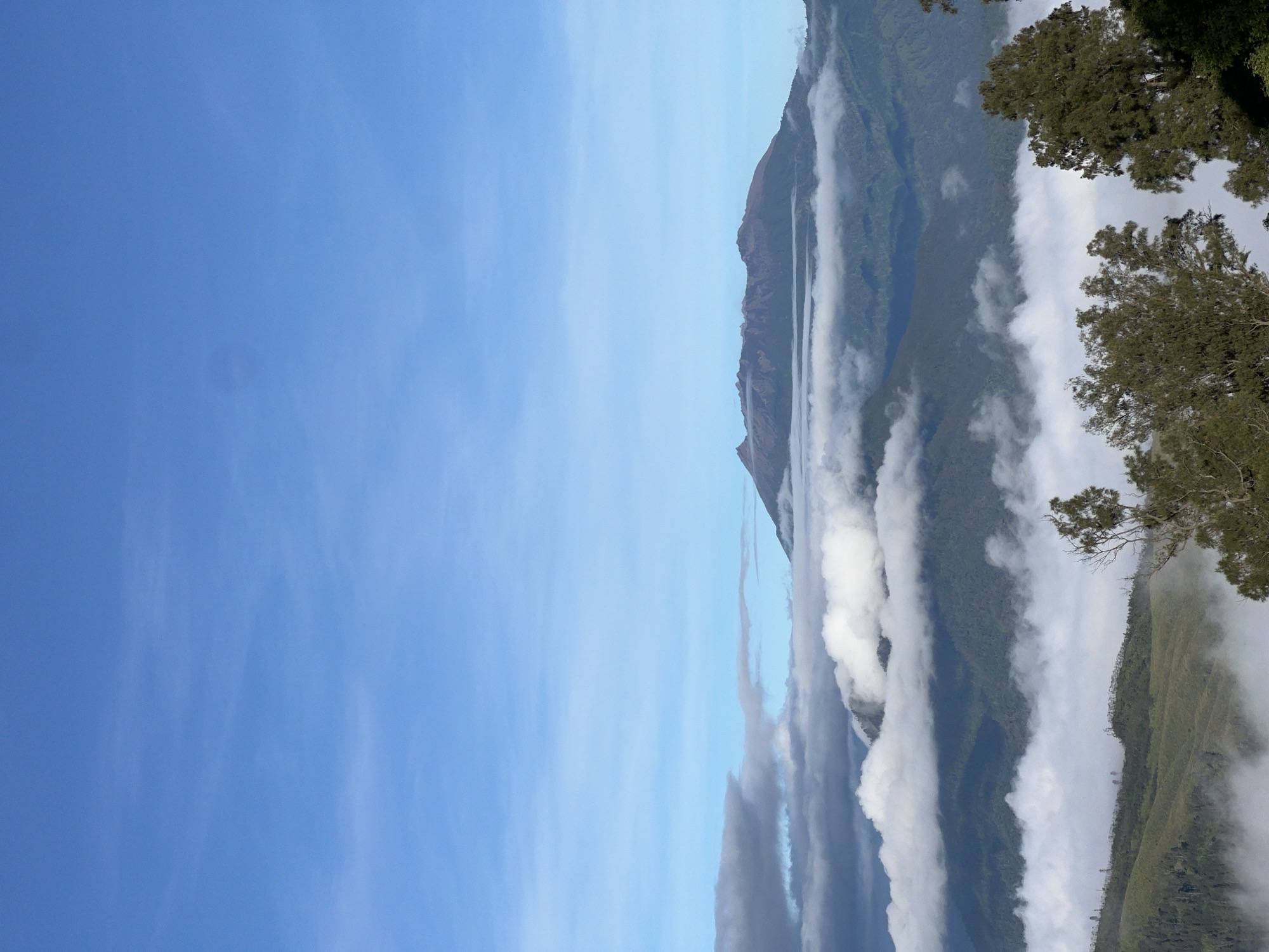 Group gathers at Indonesian mountain viewpoint on clear day