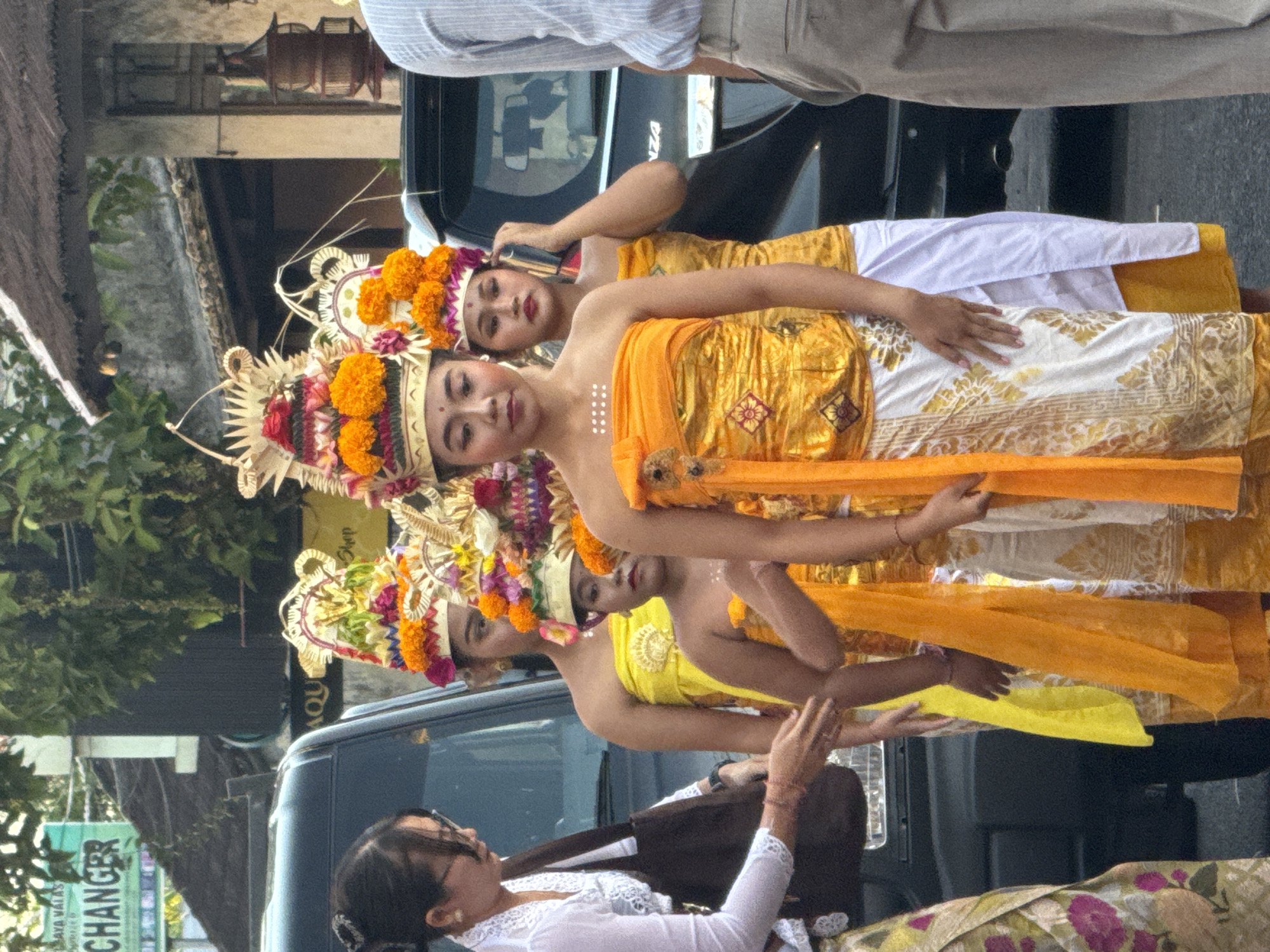 Traditional Balinese street performance with dancers, gamelan, and ceremony