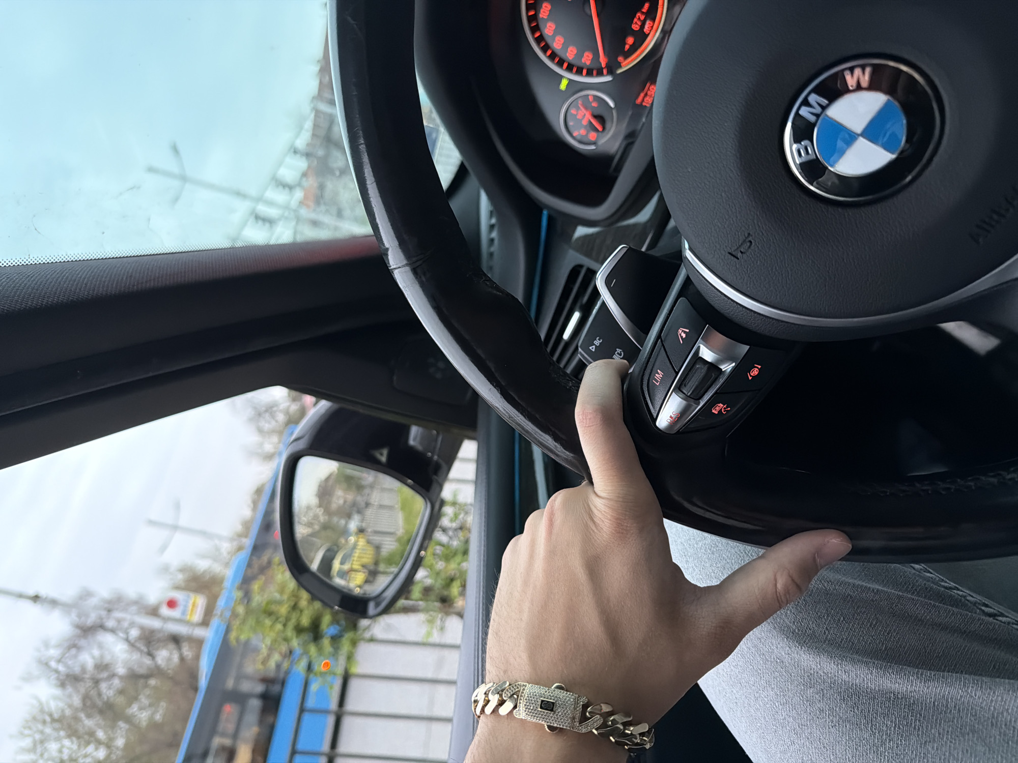 Young man documents selfie session and car details indoors