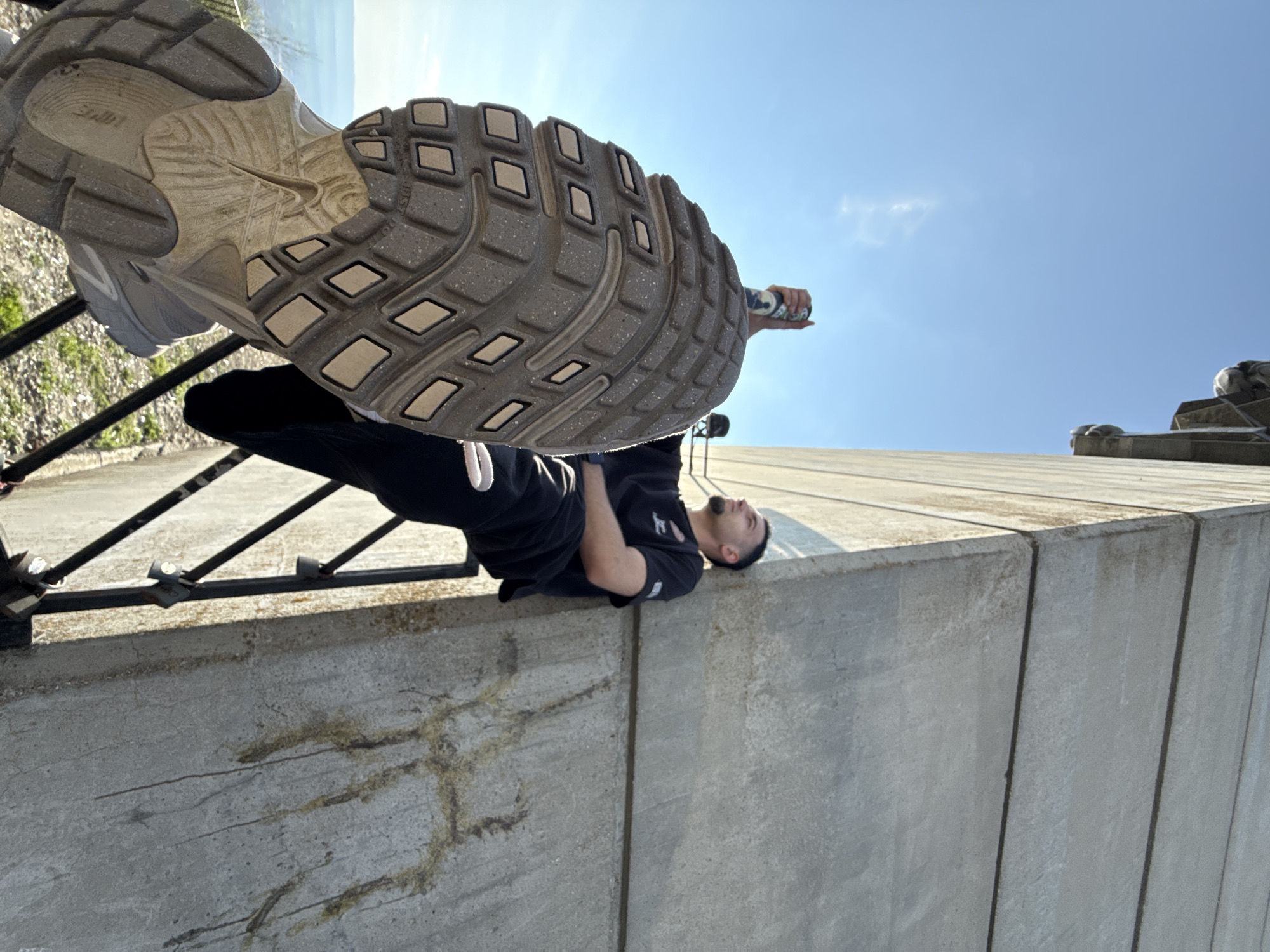 Person photographed resting on concrete ledge in Shumen