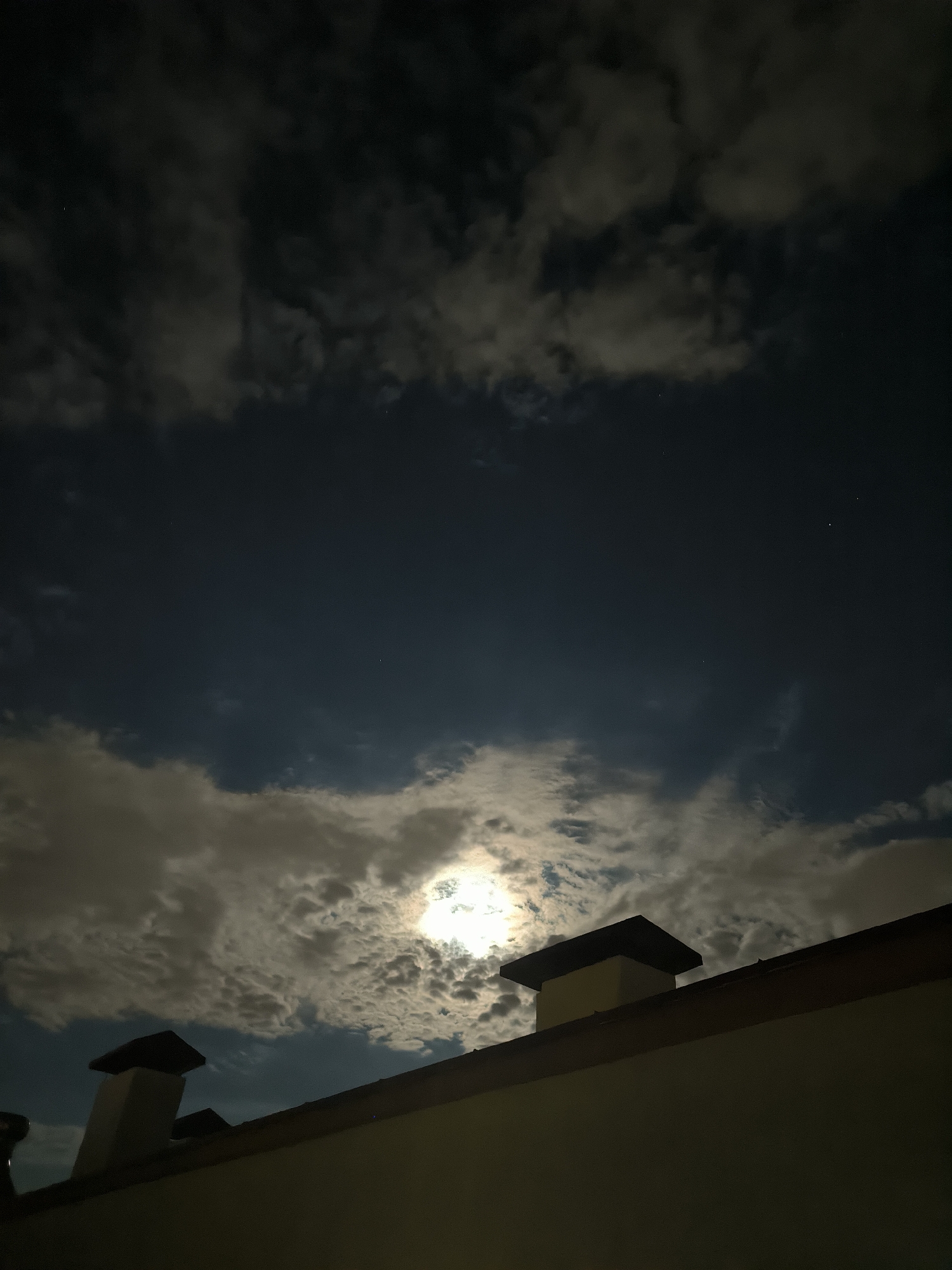 Moonlit clouds drift over Chișinău rooftops on a July night