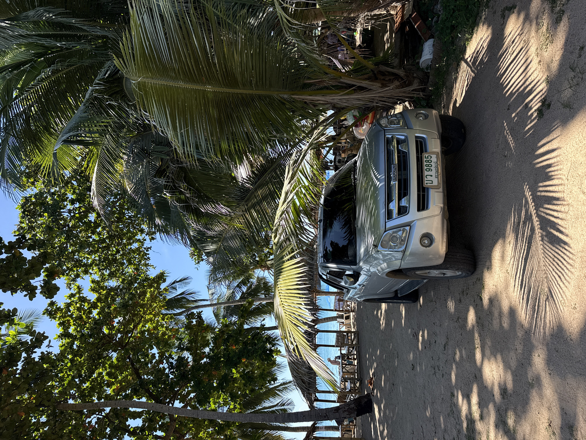 Vehicles parked beachside on Ko Samui, Thailand