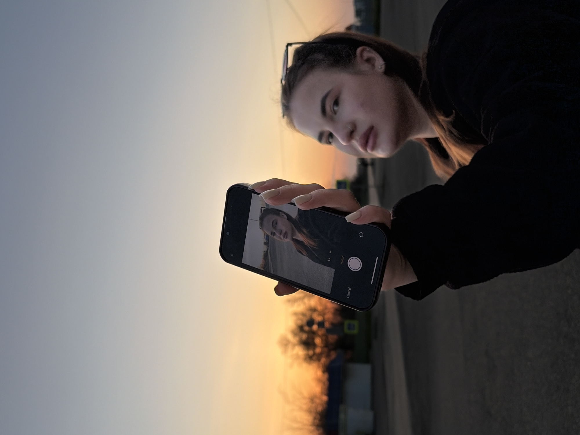 Woman takes selfies outdoors in Novopokrovskaya, Russia