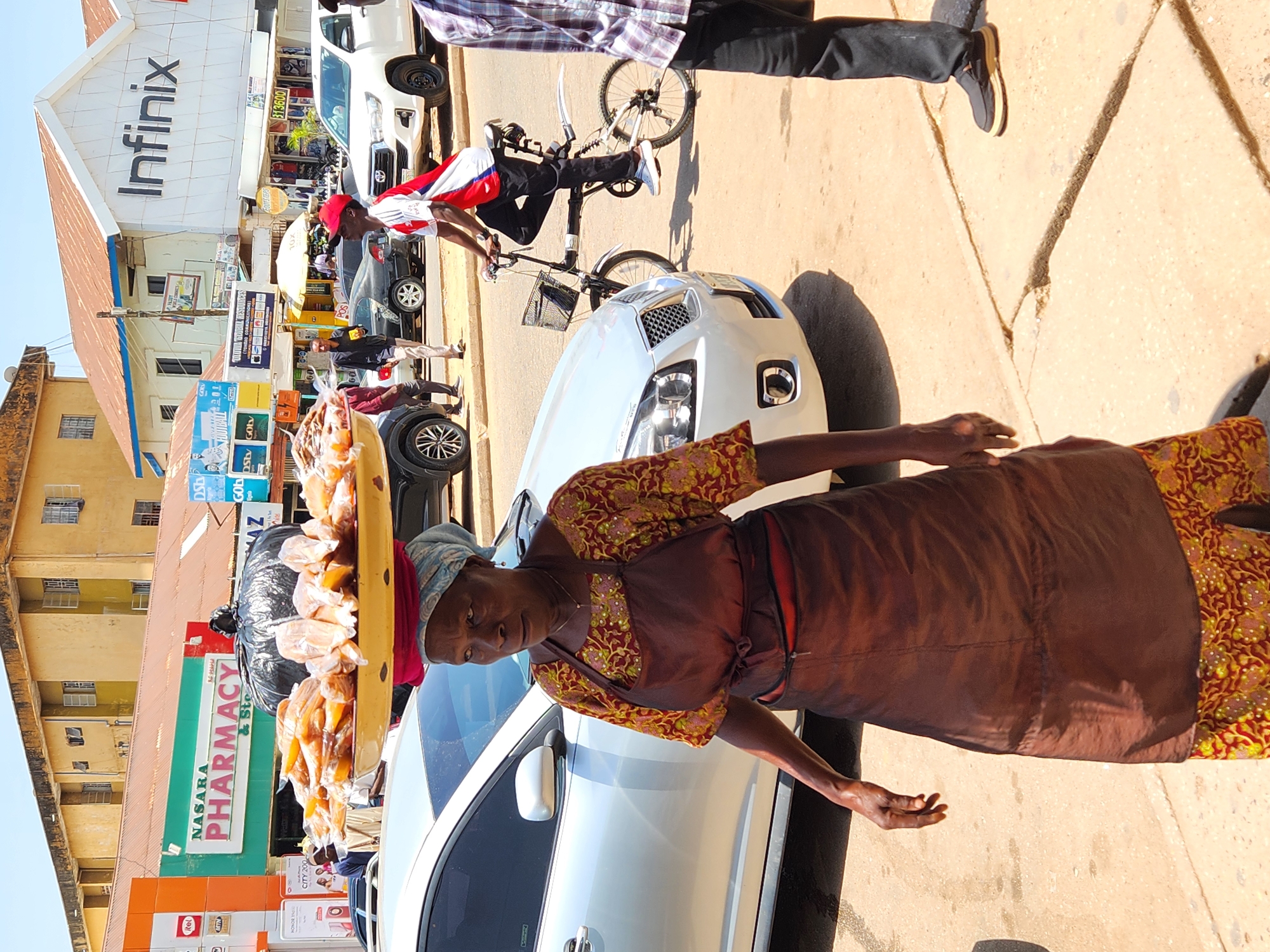 Street vendors conduct daily business in urban marketplace