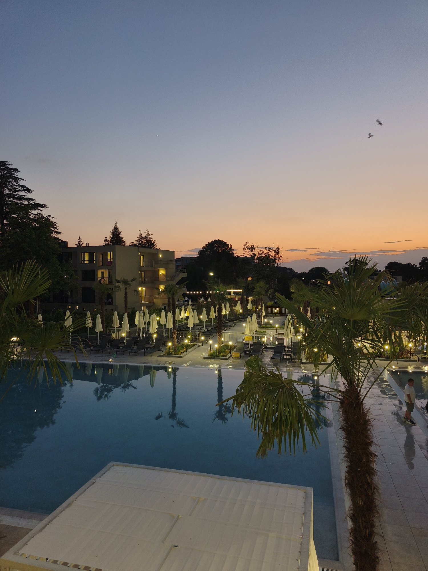 Evening at a beach resort town, pool to night market