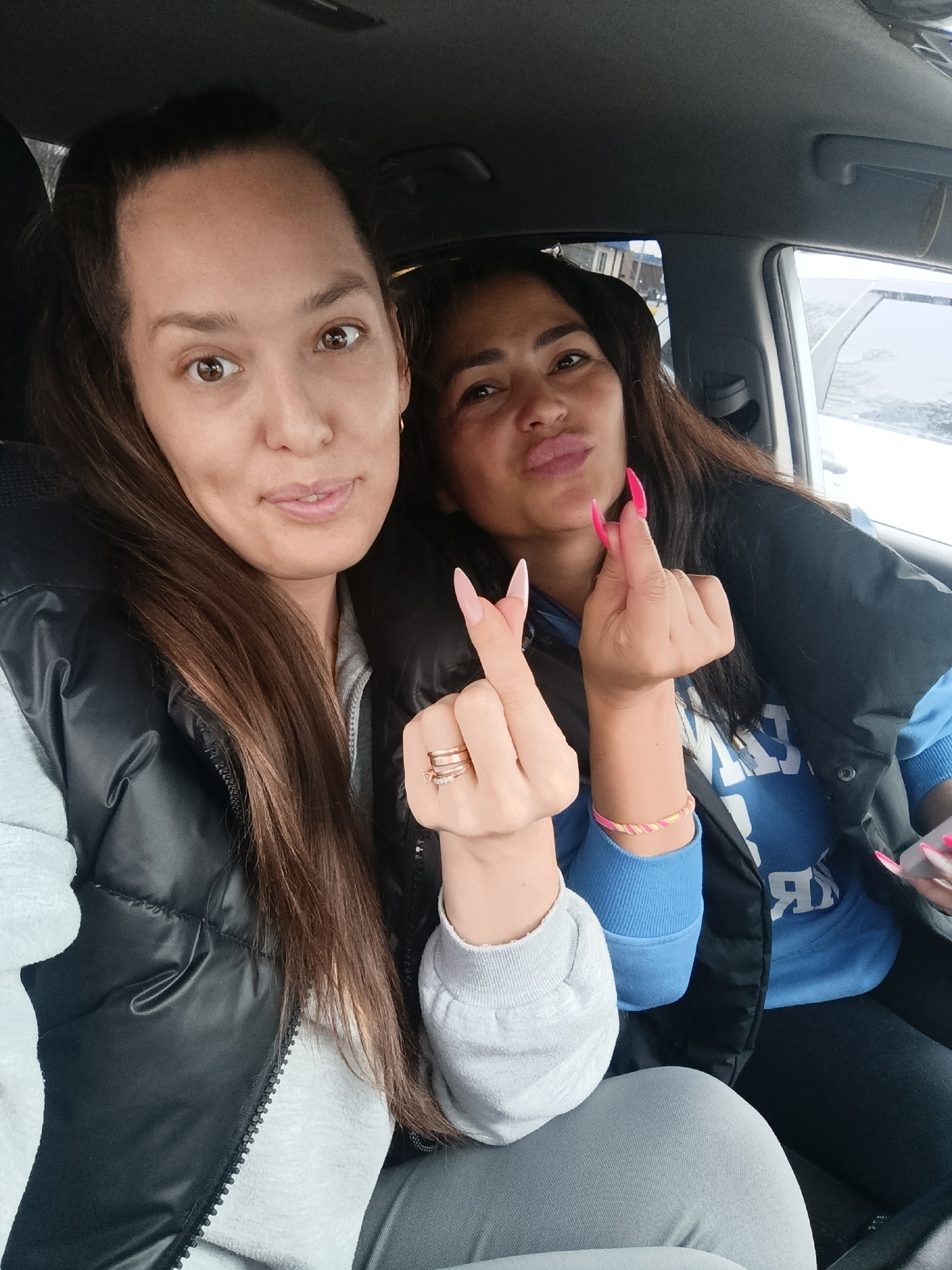 Two women share casual car selfies in Chaikovsky, Russia