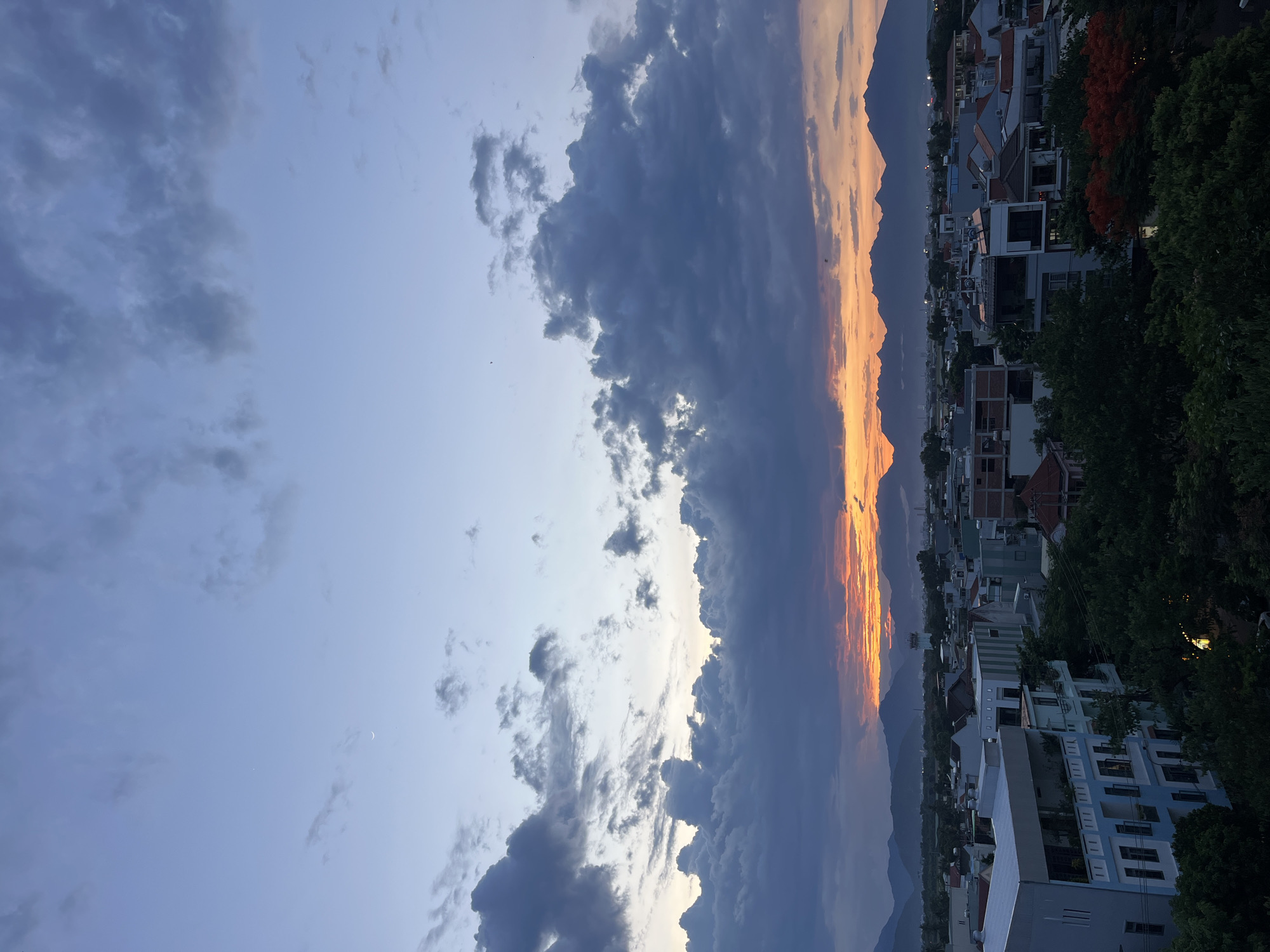 Storm clouds meet golden sky over Đà Nẵng at dusk
