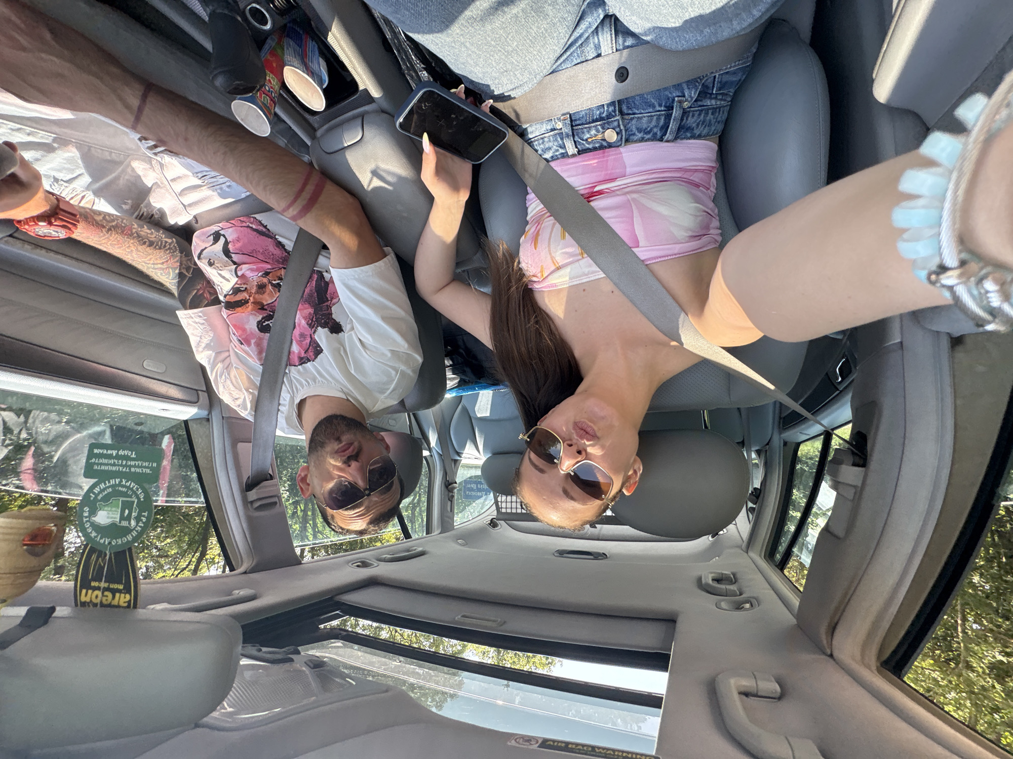 Two people take selfie in car in Primorsko, Bulgaria