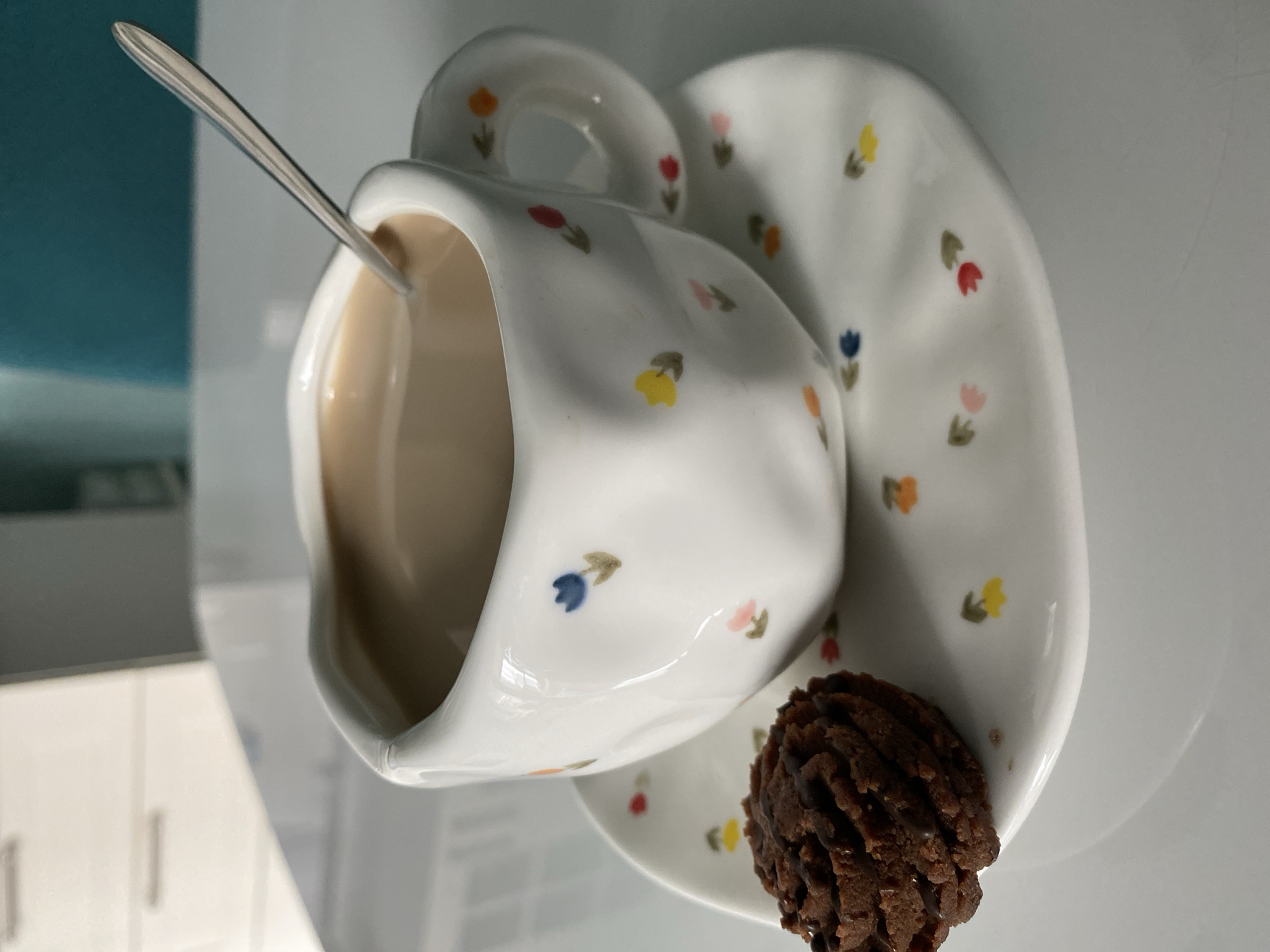 Studio tea cup photograph captured with chocolate cookie detail