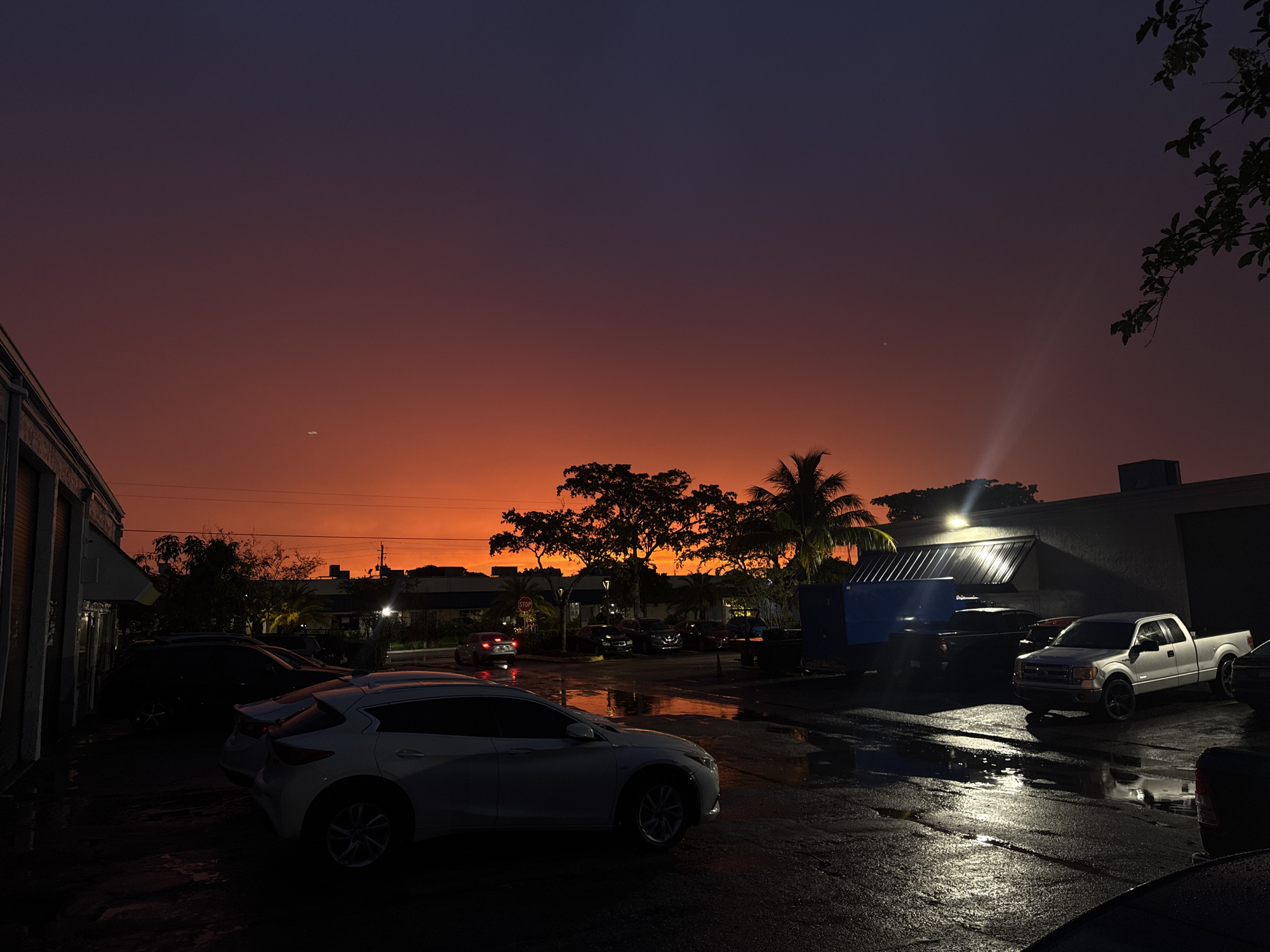 Industrial skyline at dusk, indigo to fiery orange gradient