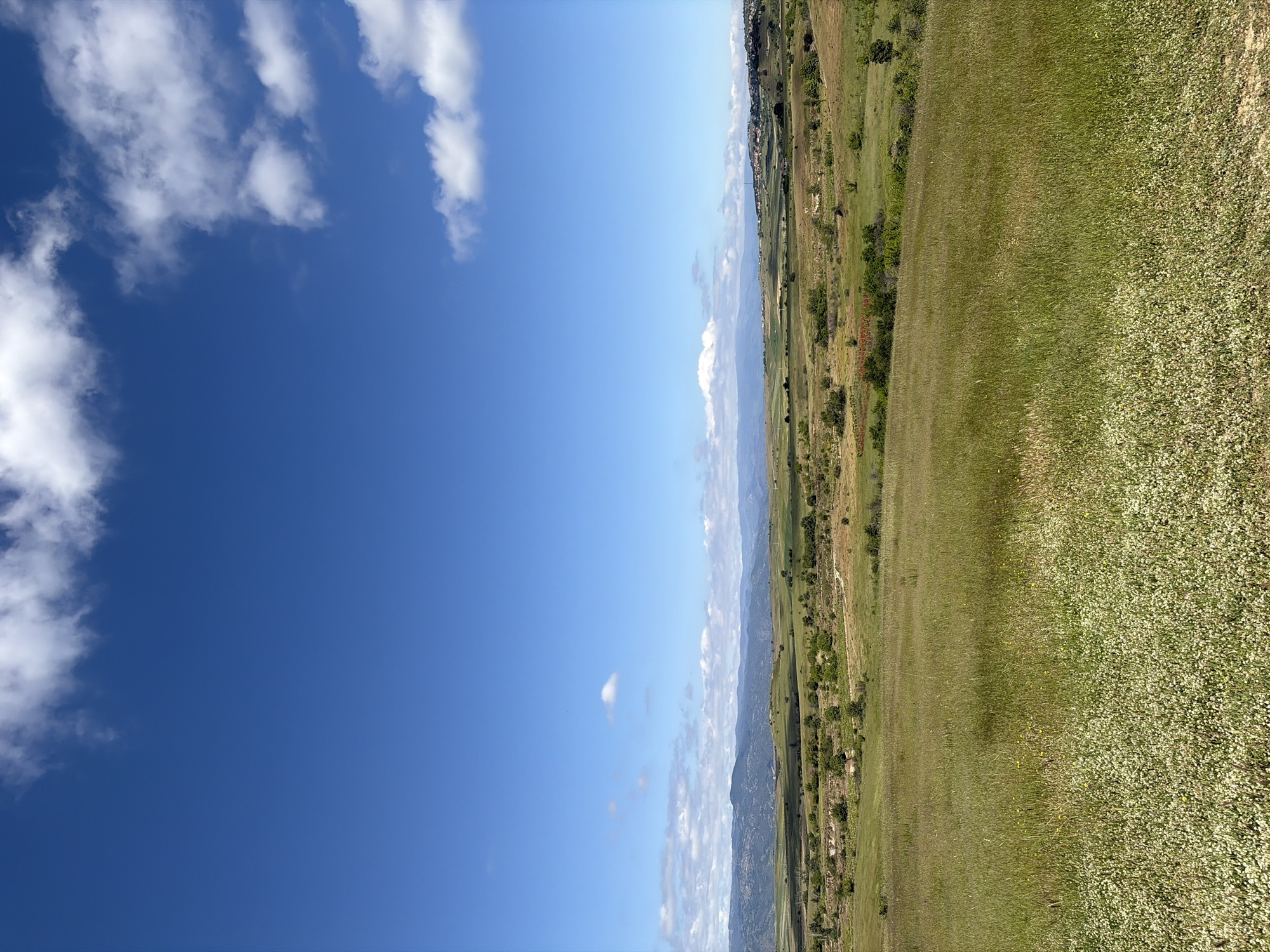 Pastoral landscape with mountains documented under clear skies