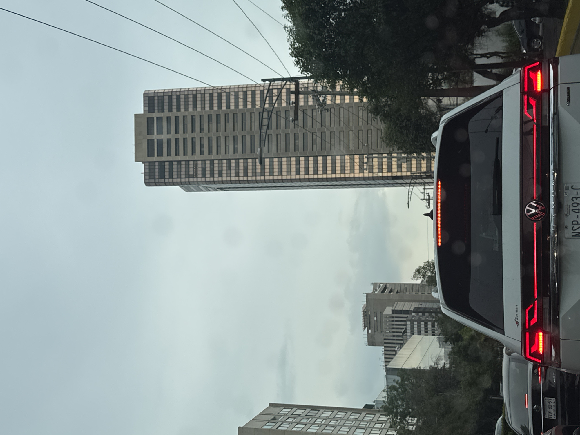 Urban street photographed from elevated view under overcast evening sky