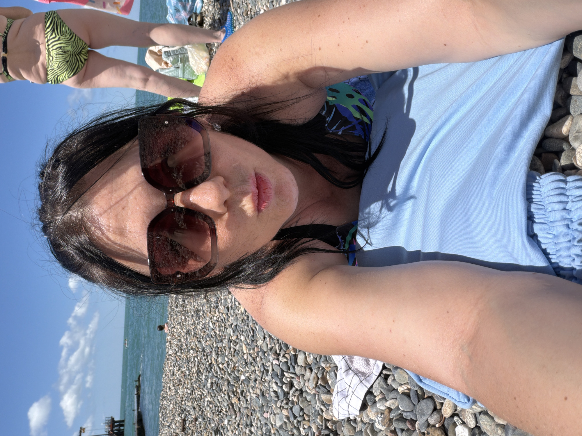 Relaxing on Sochi's Black Sea pebble beach on a sunny morning