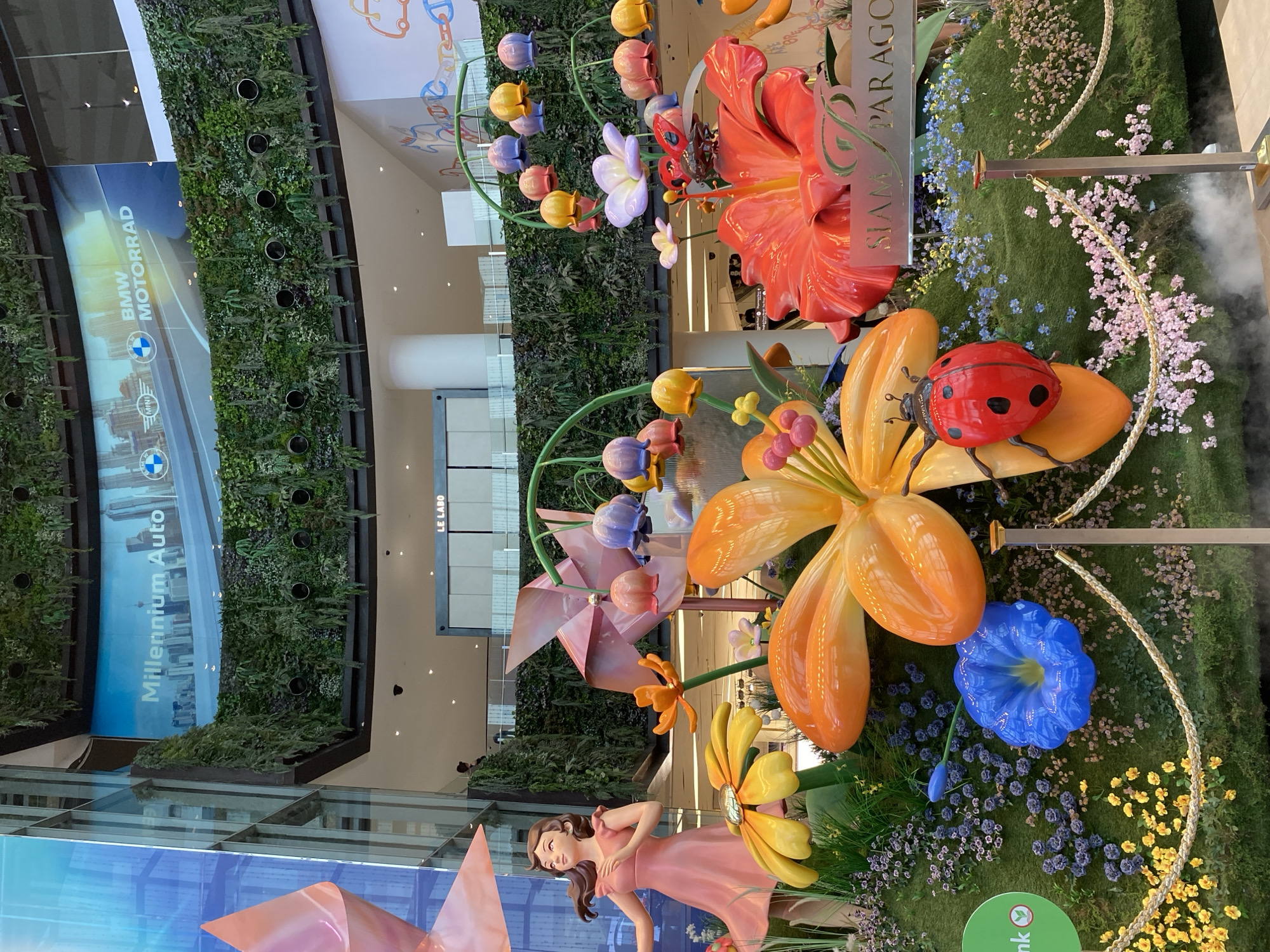 Decorative displays featuring flowers and adorned lion statues observed in Bangkok