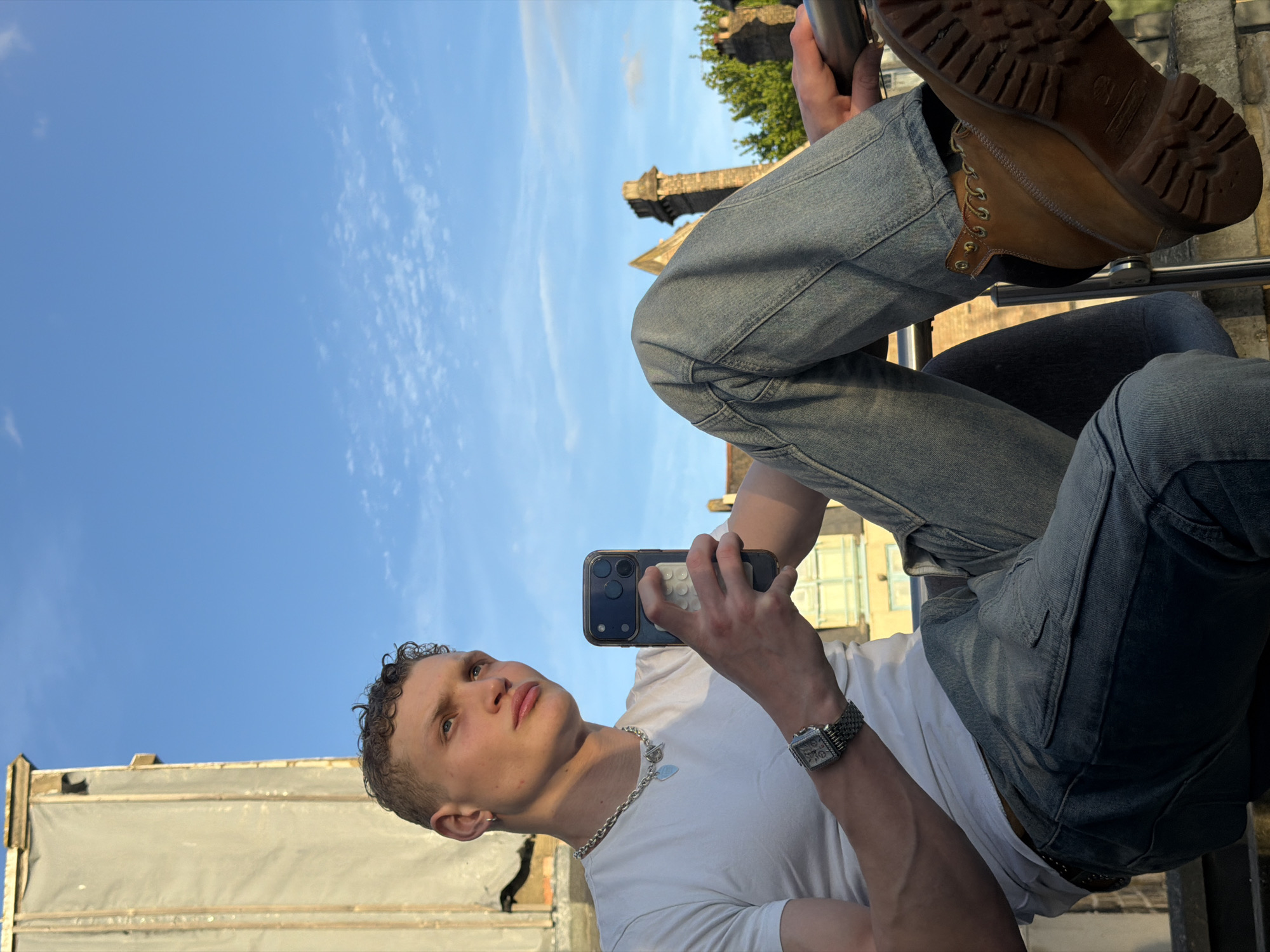Young man takes selfies against London wall Friday evening