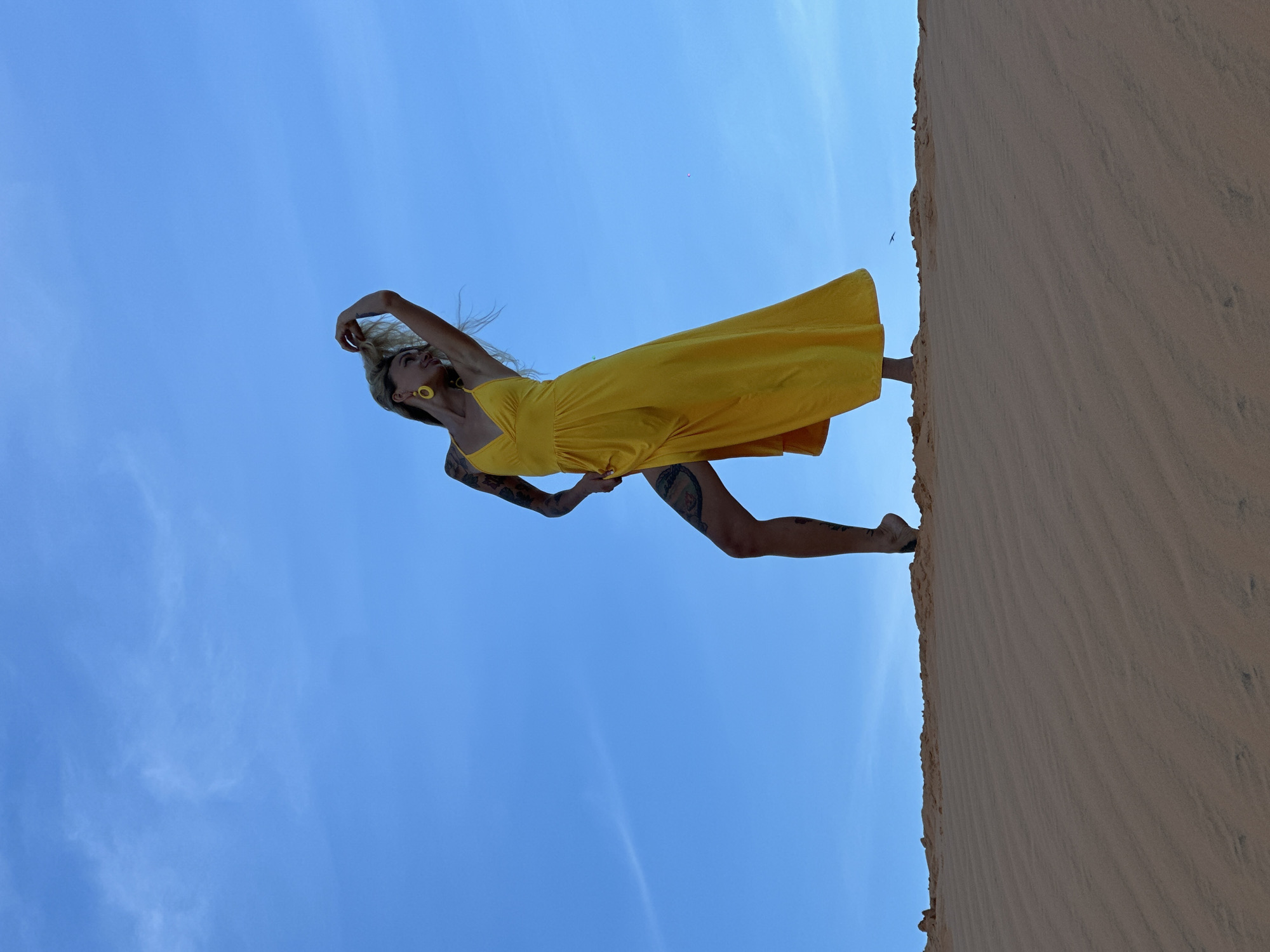 Portrait shoot on the Mui Ne sand dunes, yellow dress, blue sky
