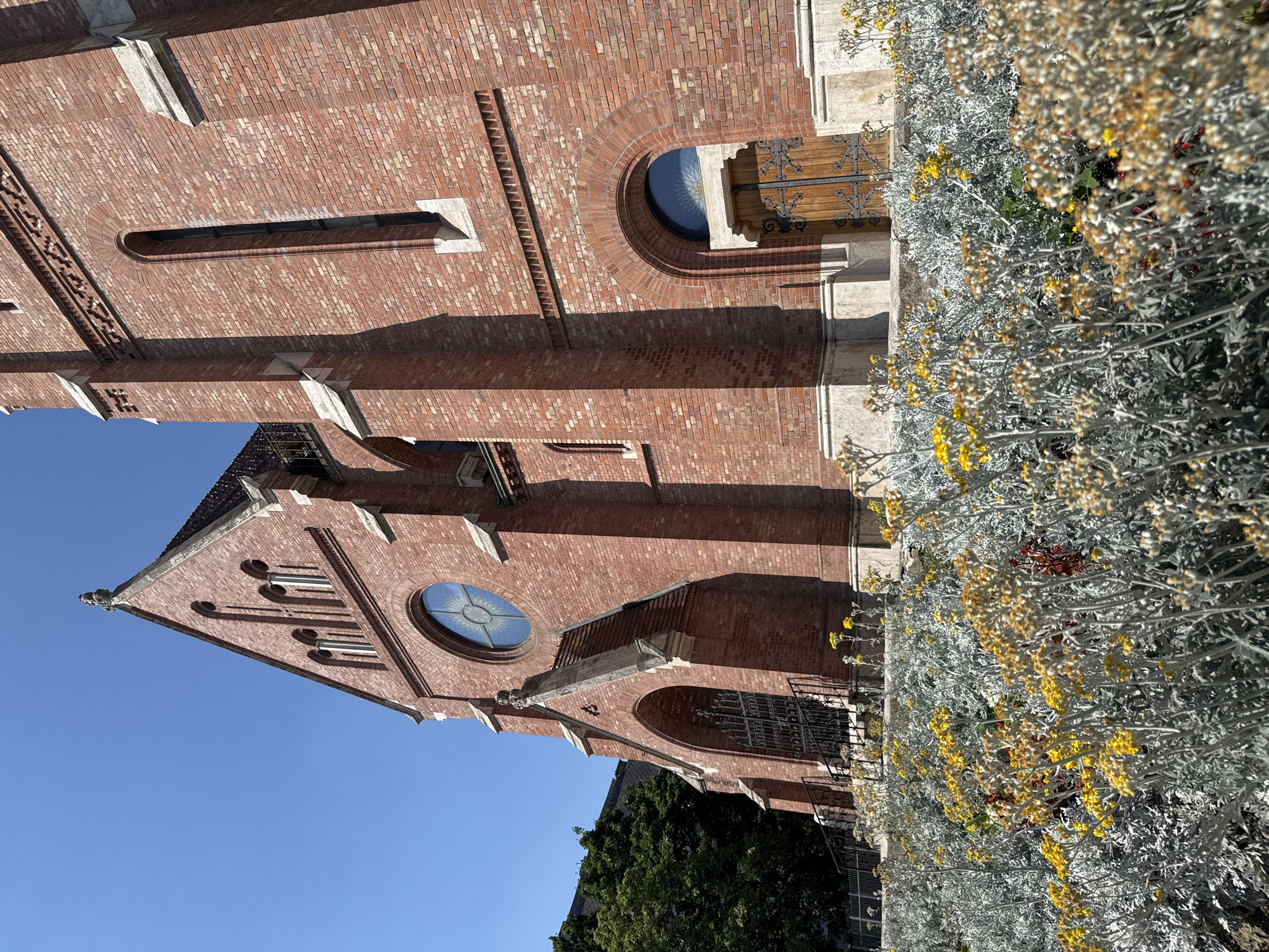 Gothic Revival red brick church in Budapest, clear summer day