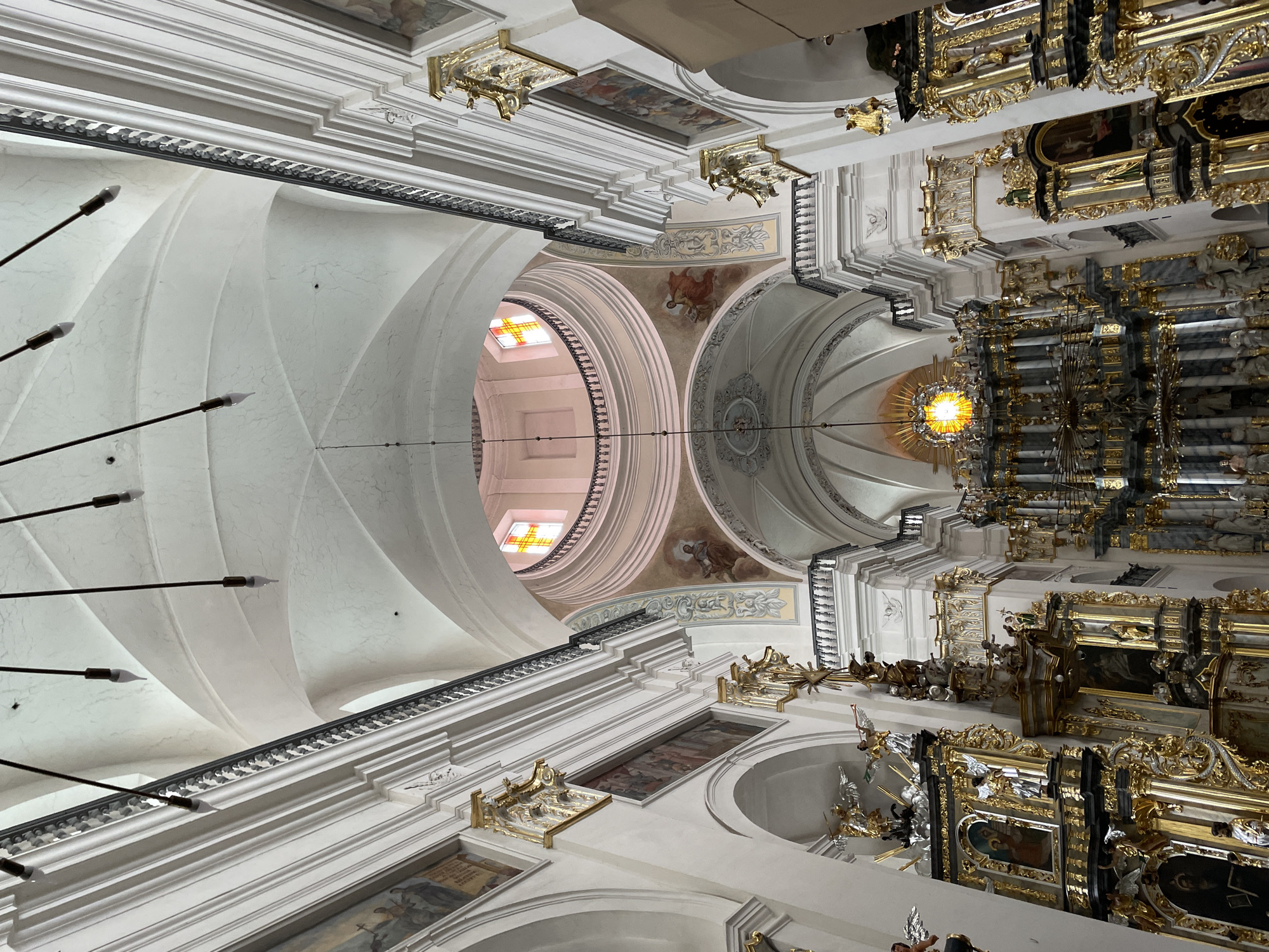 Visitor documents ornate Baroque church interior and exterior in Hrodna