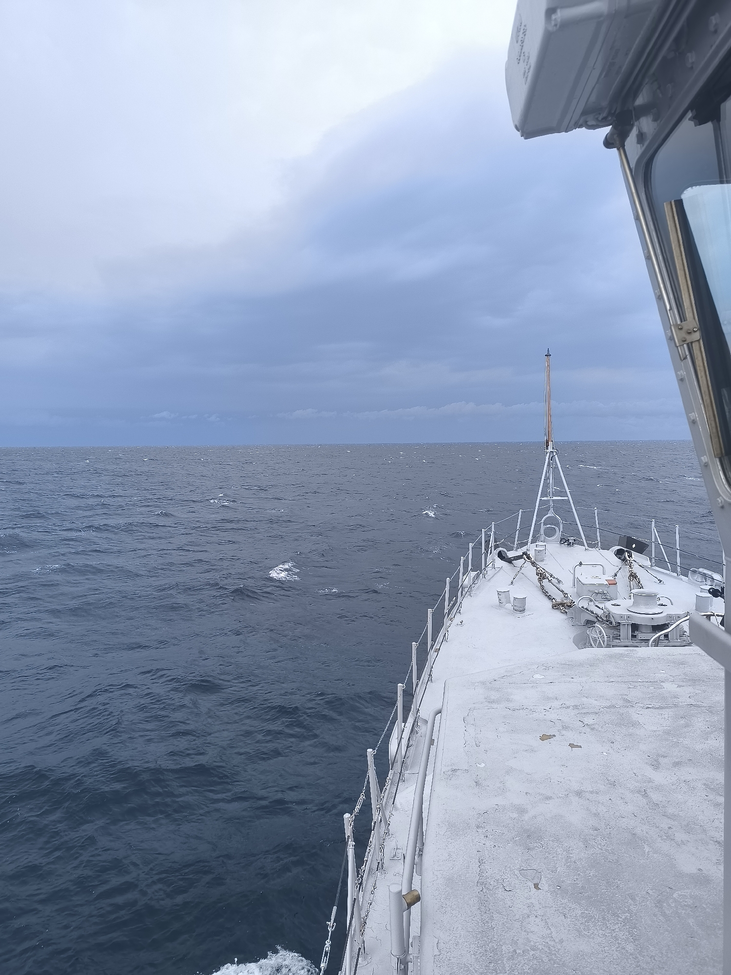 On deck aboard a weathered ship under grey skies