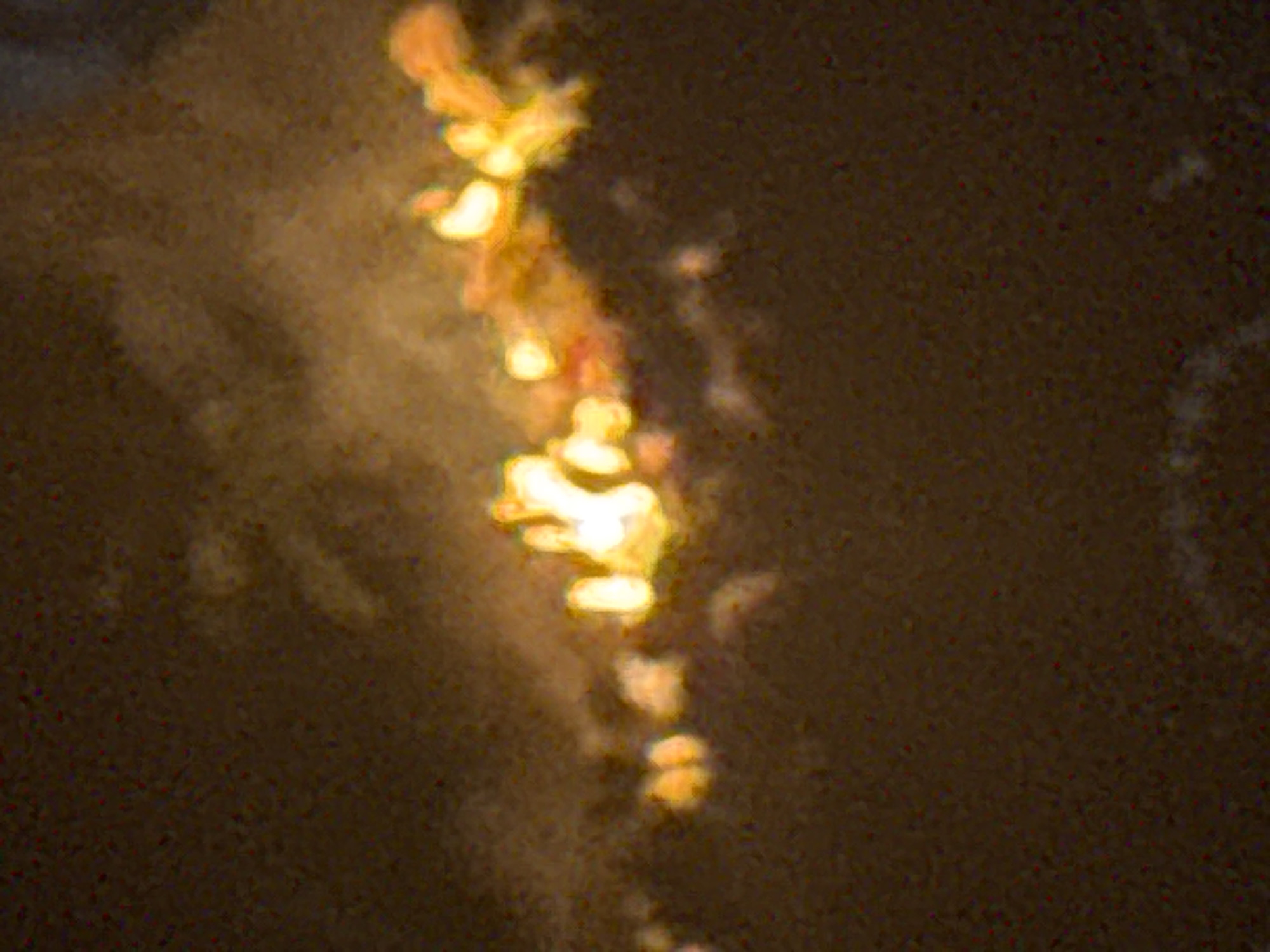 Nighttime hillside fire observed behind fence in Ihiagwa, Nigeria