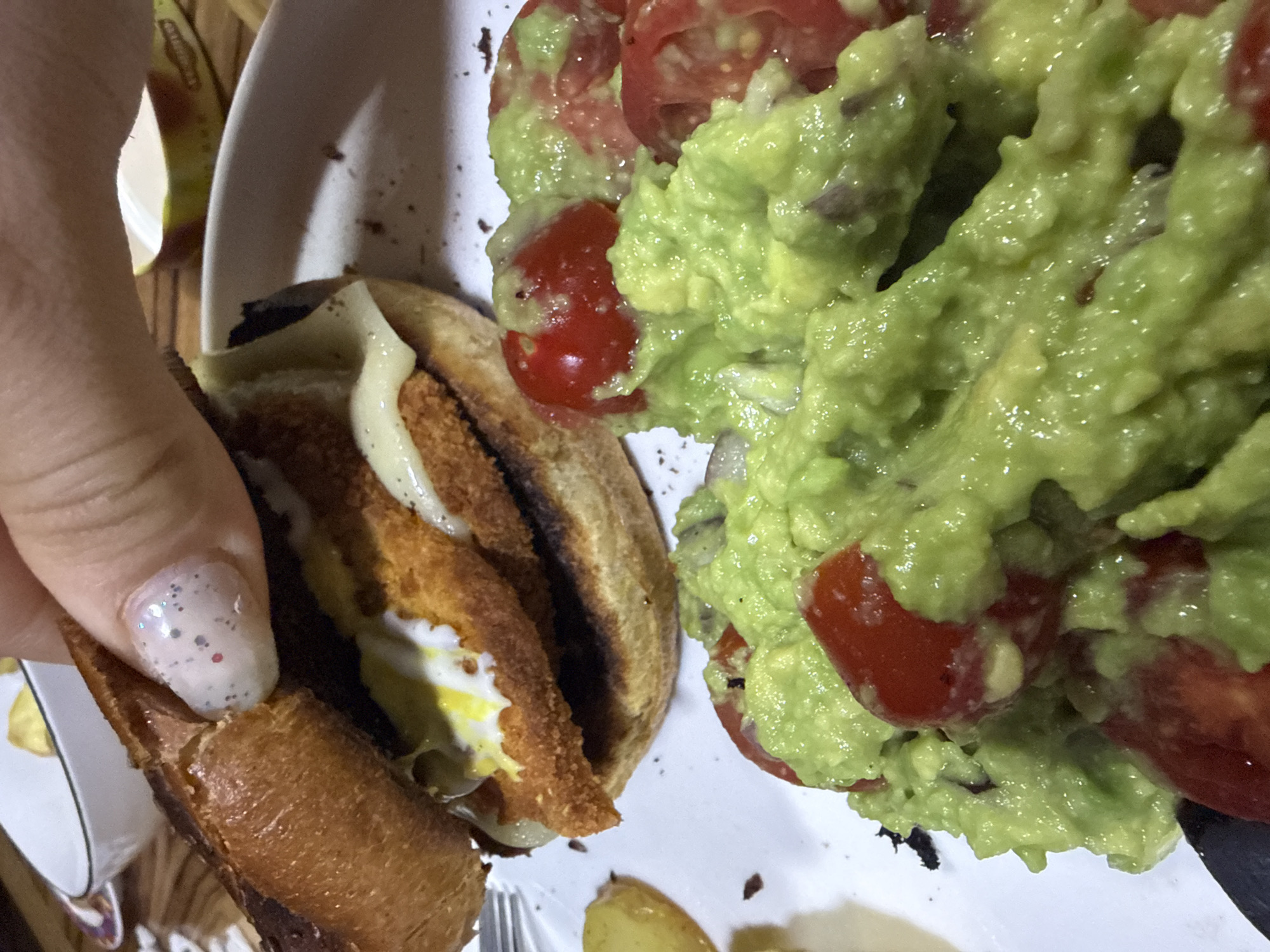 Person prepares sandwich meal with guacamole in Troyan, Bulgaria