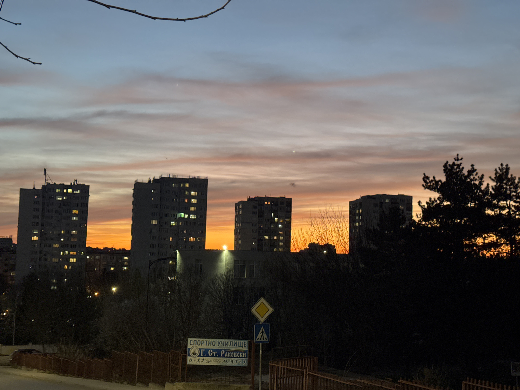Evening illumination captured across Dobrich's apartments and Orthodox church