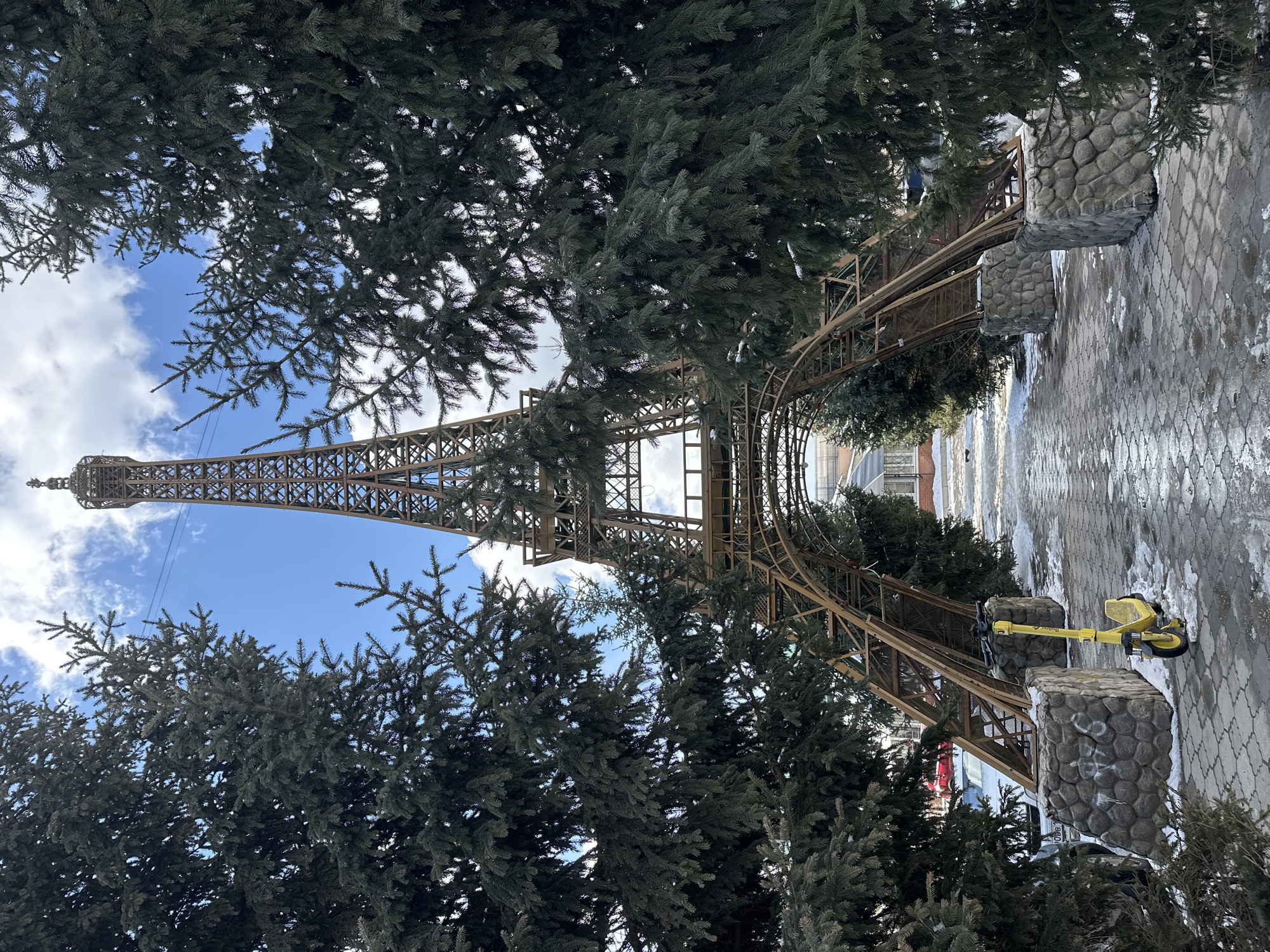 Tourist photographs Eiffel Tower replica in snowy Krasnoyarsk