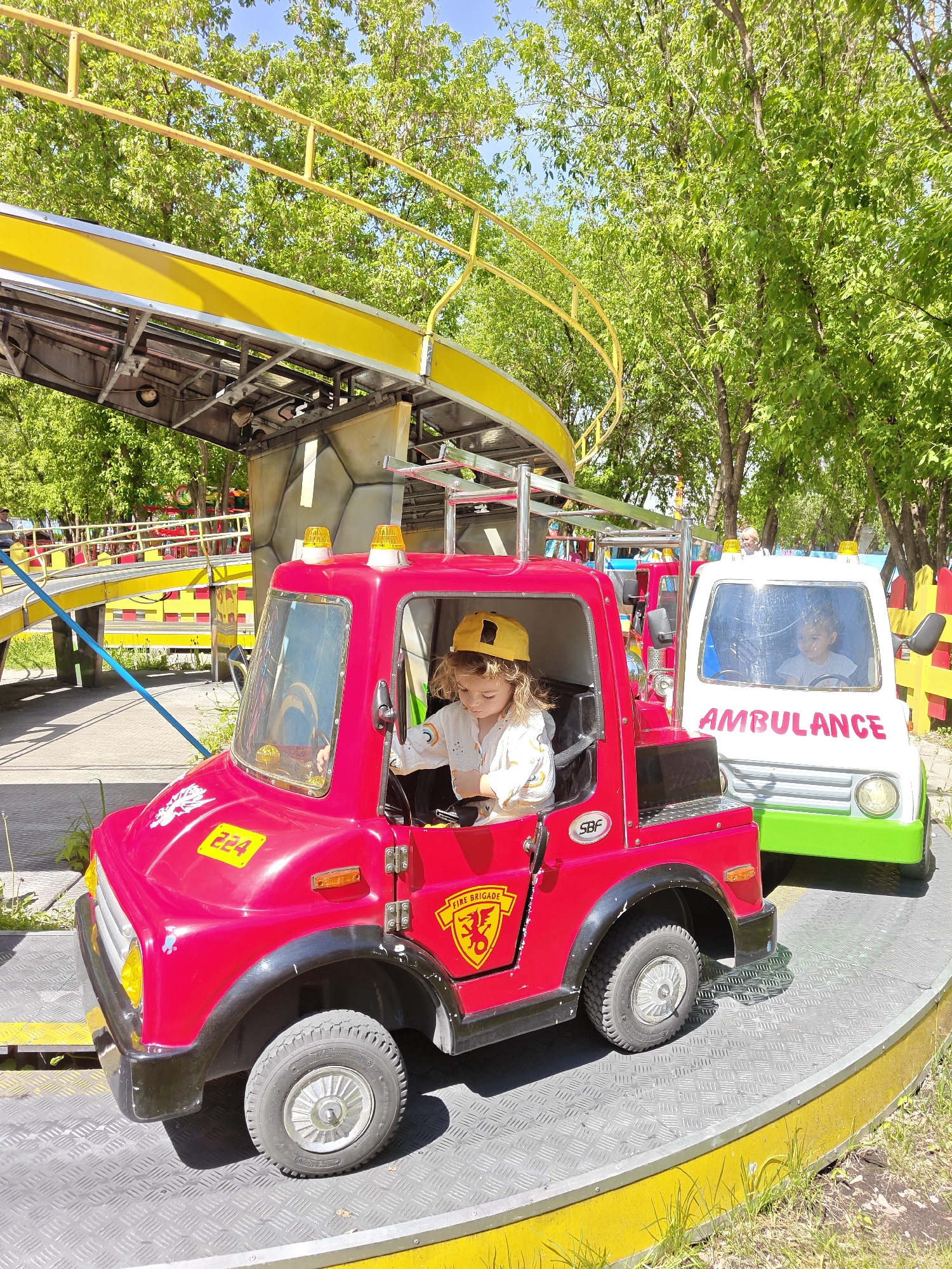 Child enjoys playground rides in Khimki recreational area