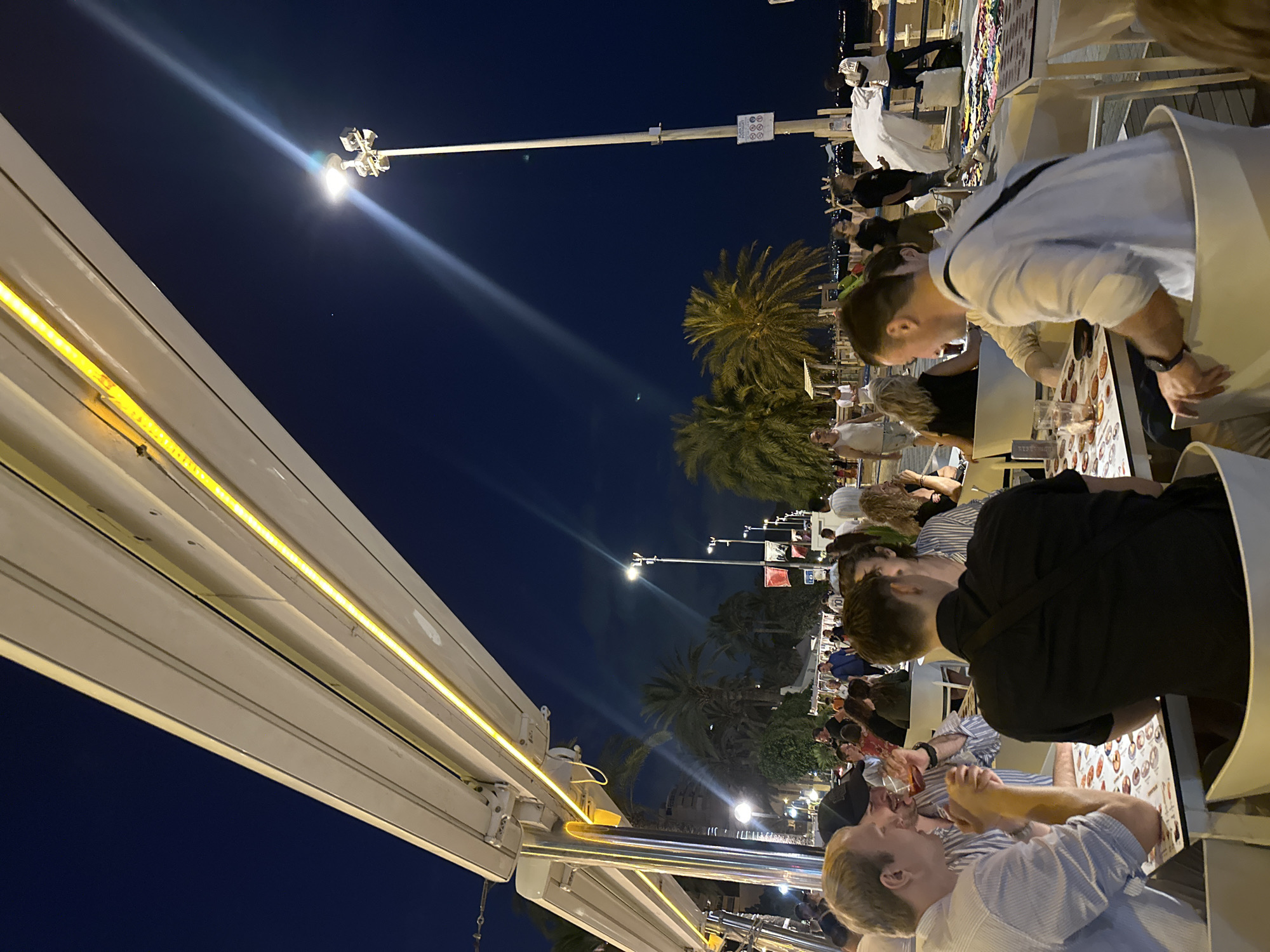 Diners enjoy tropical themed waterfront restaurant with octopus sculpture