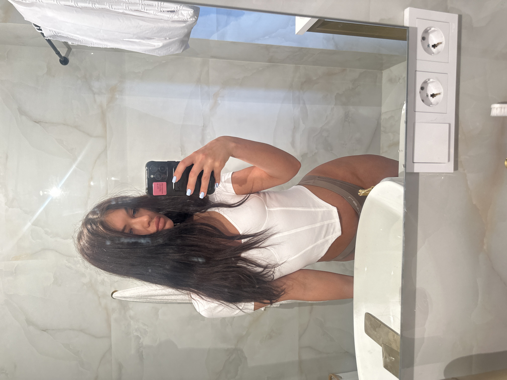 Woman takes bathroom mirror selfies in Moscow