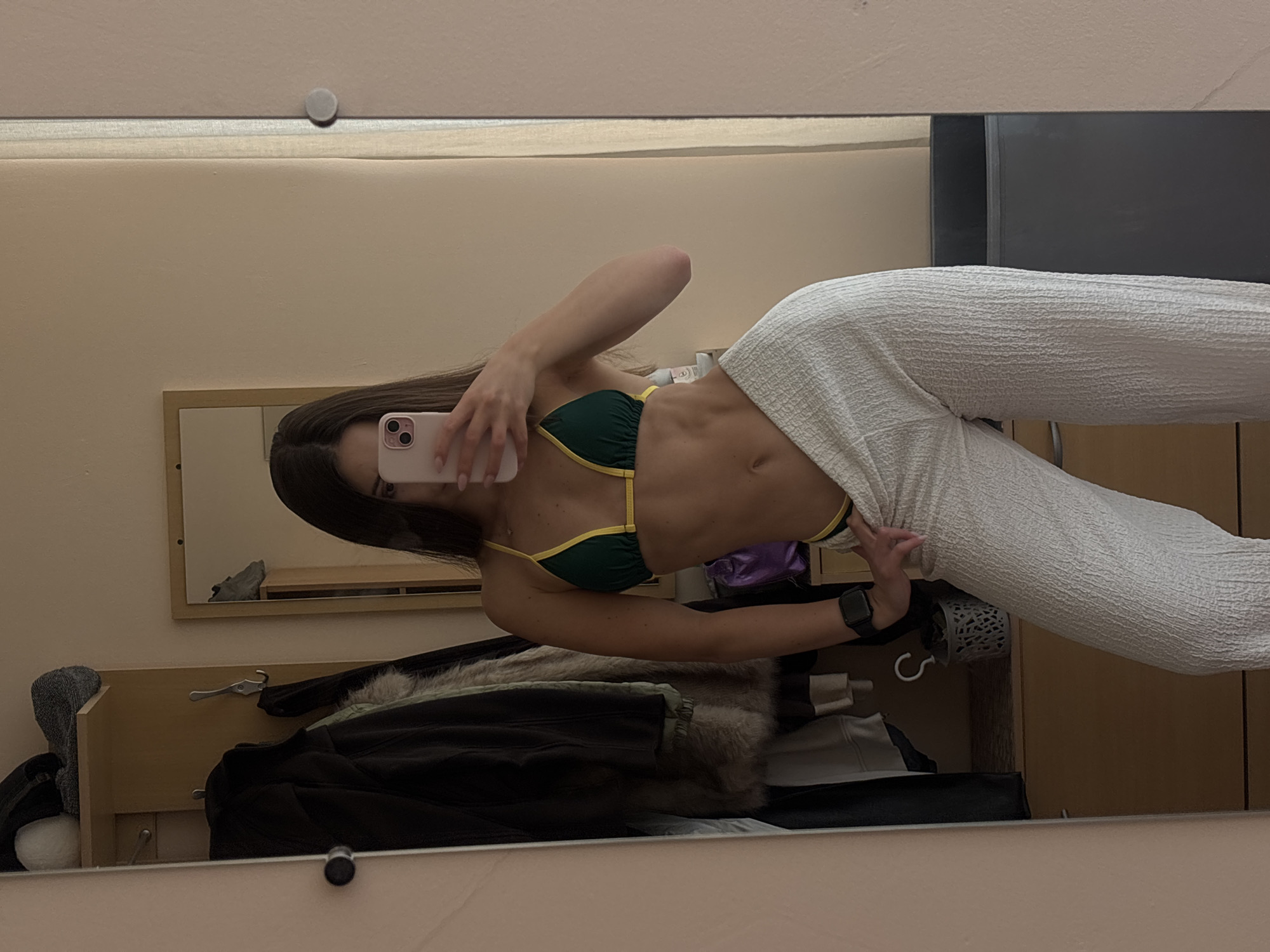 Mirror selfie in Varna bedroom, green bikini and white pants