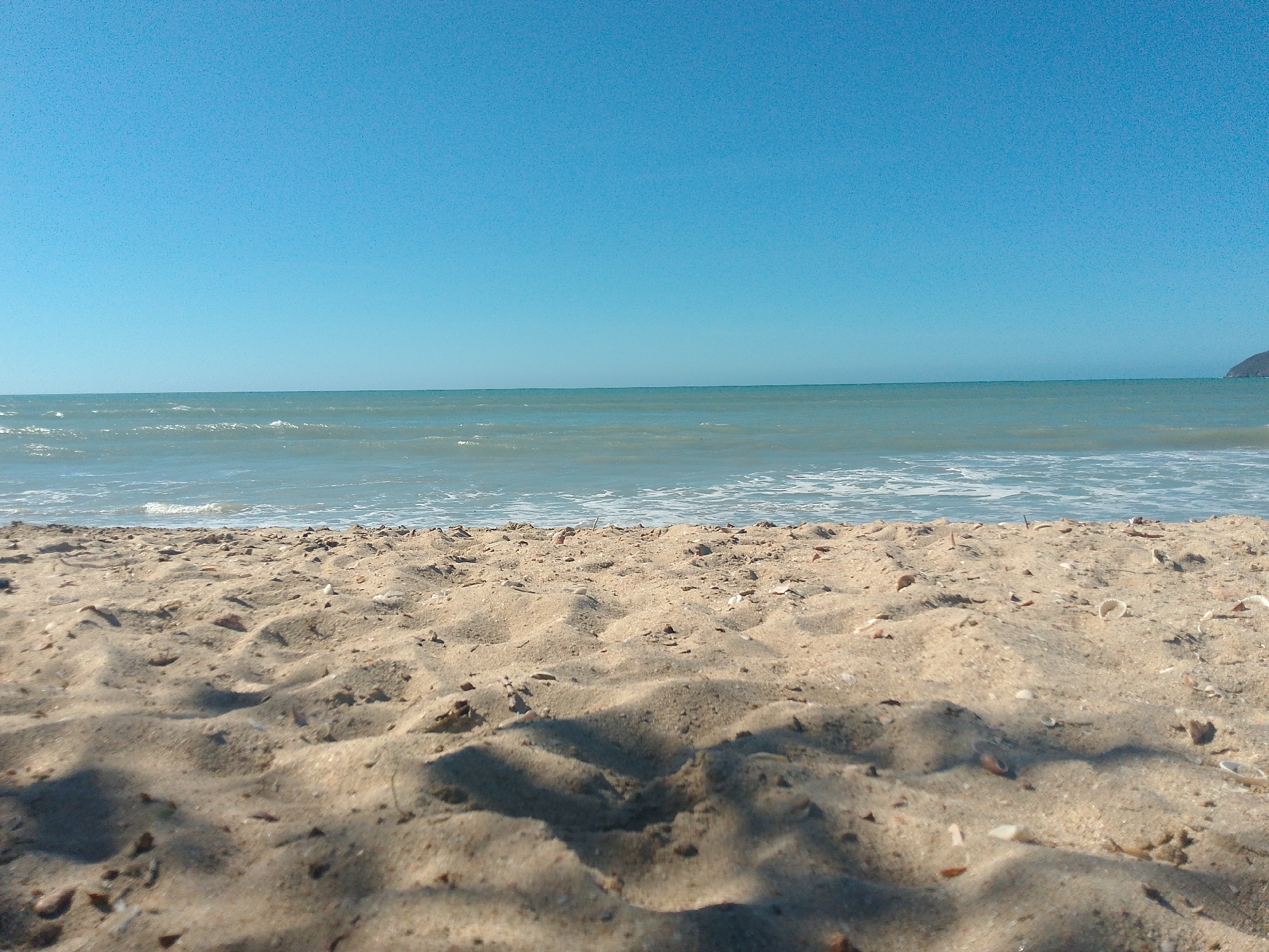 Woman takes beach selfie in Juan Griego, Venezuela
