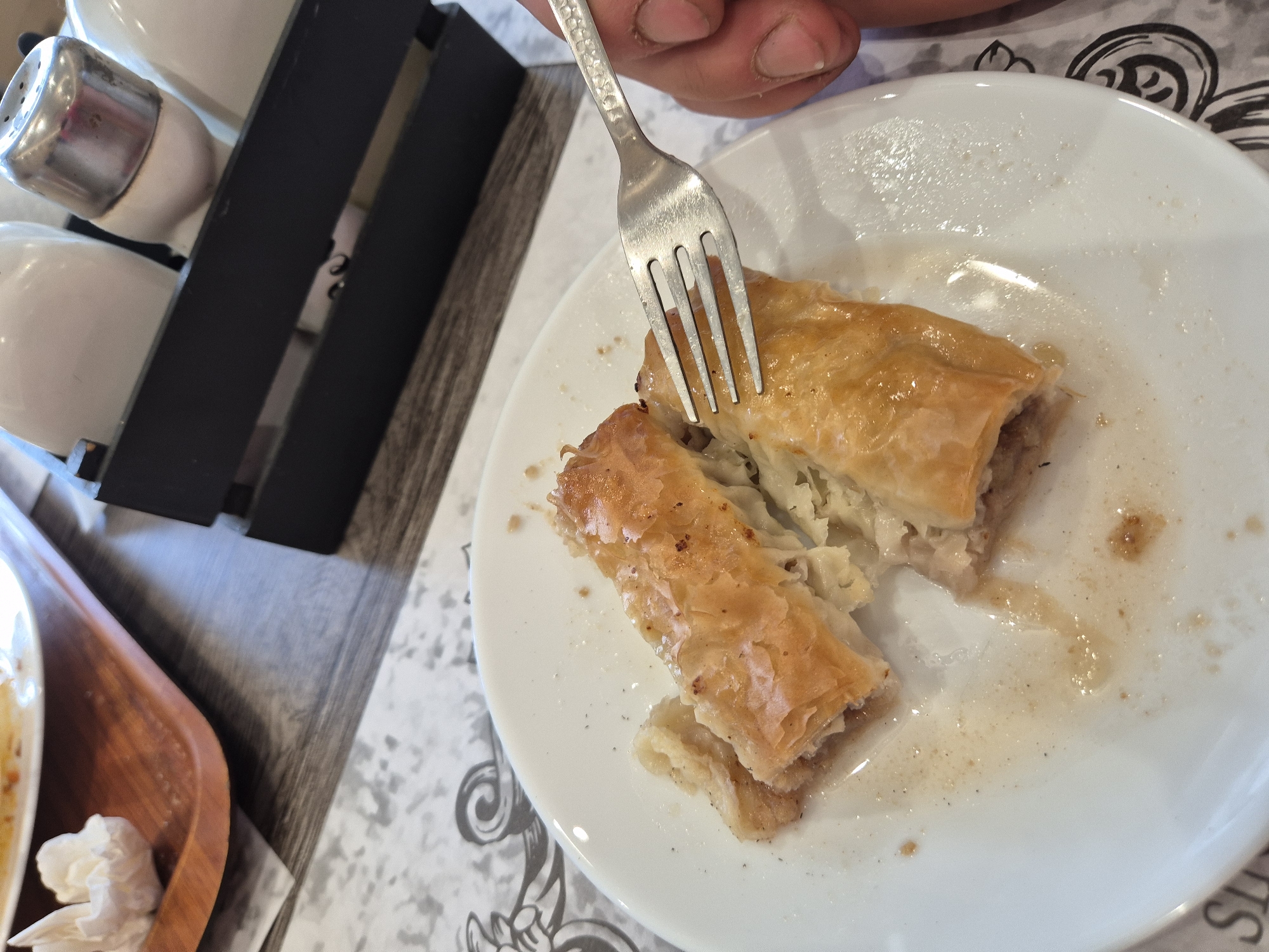 Person enjoys baklava dessert as guilty pleasure in Bulgaria