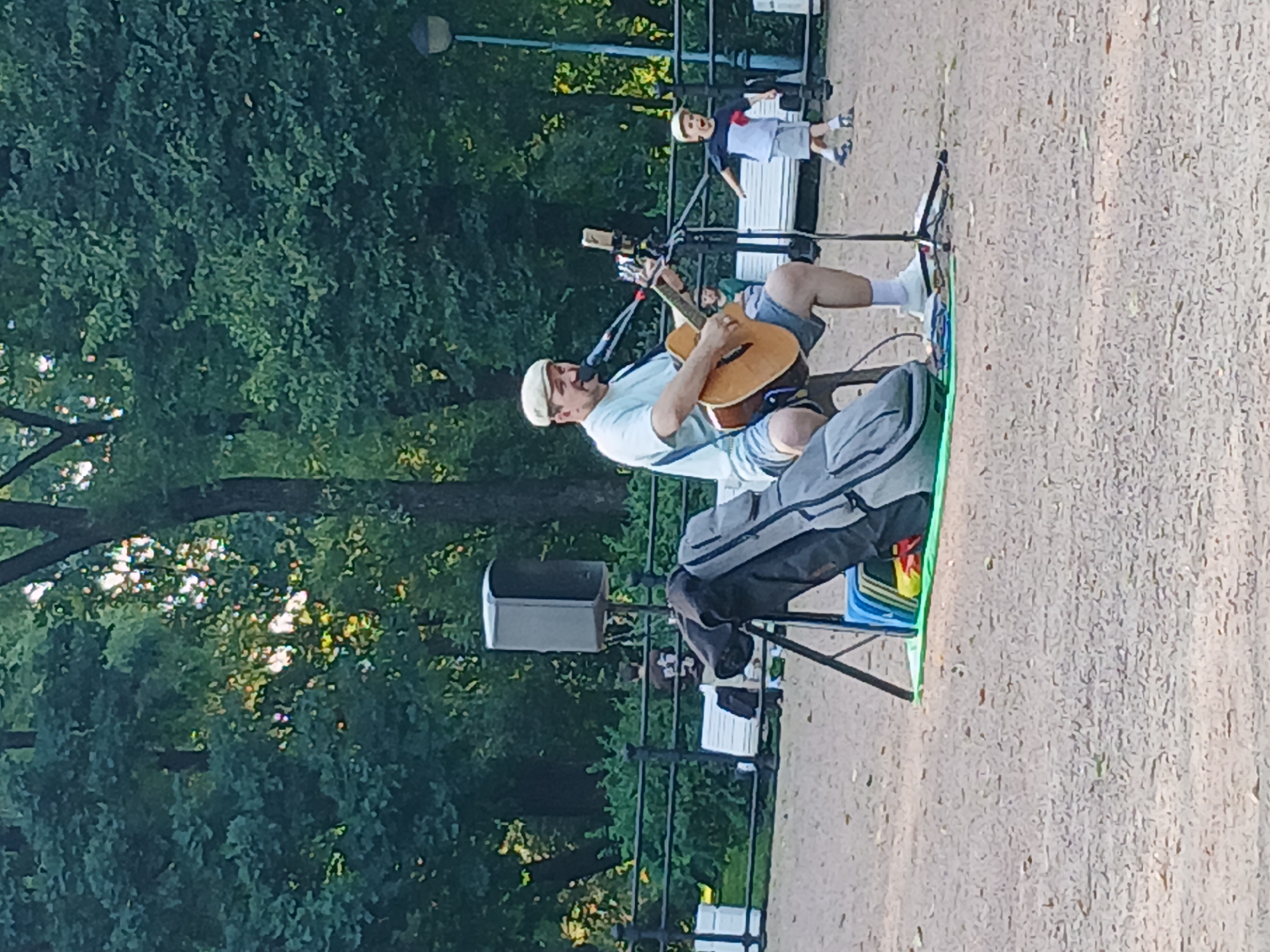 Acoustic guitar session set up in a sunlit park