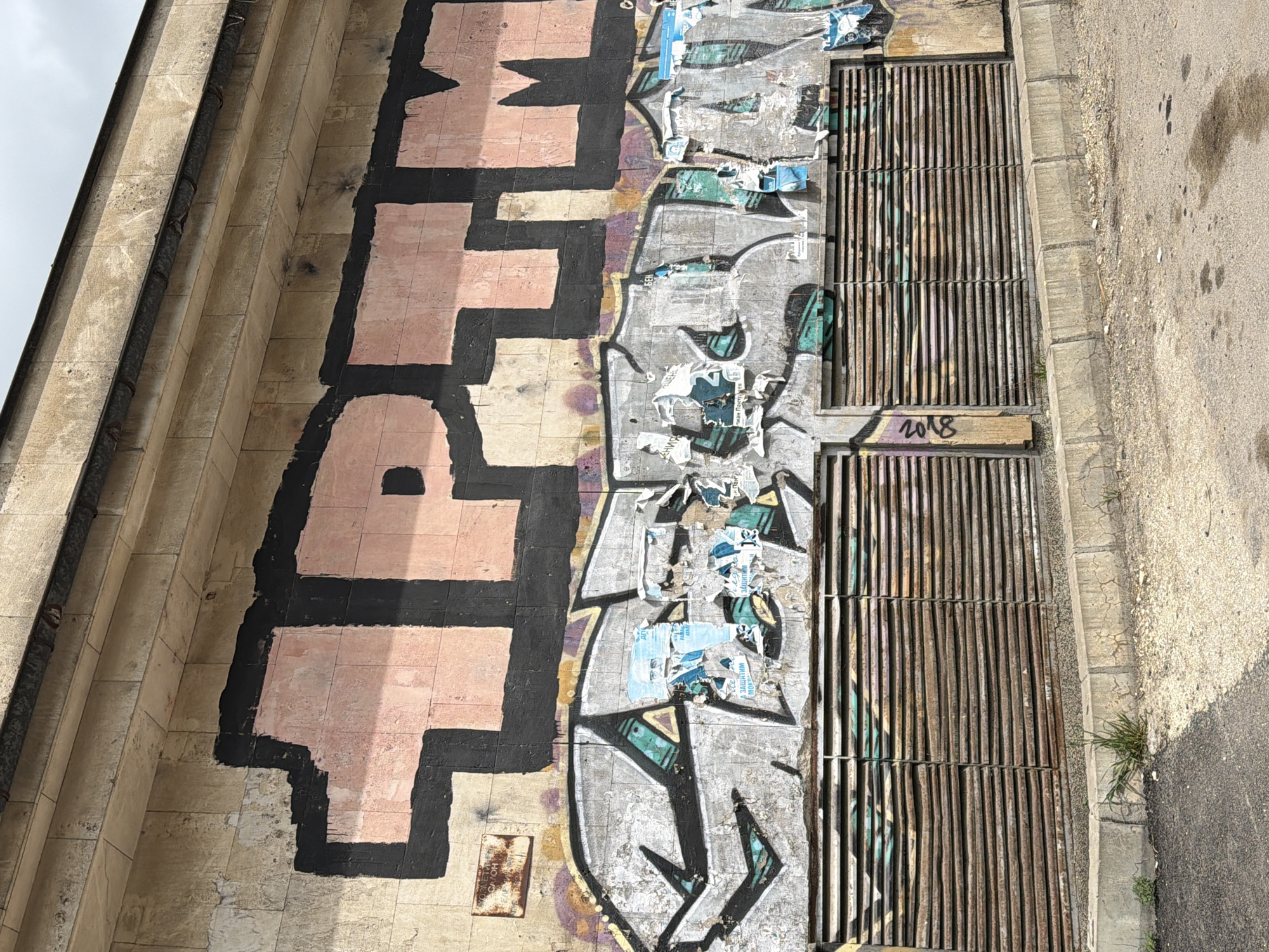 Woman in pink coat spotted in urban graffiti area