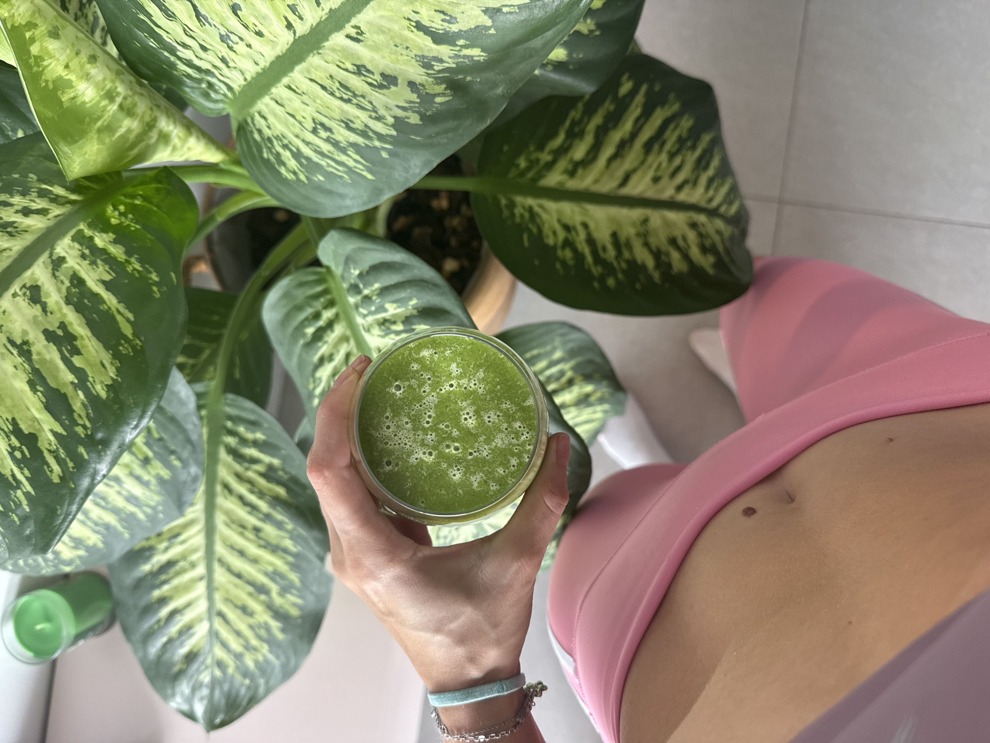 Person drinks green smoothie in Givatayim, Israel