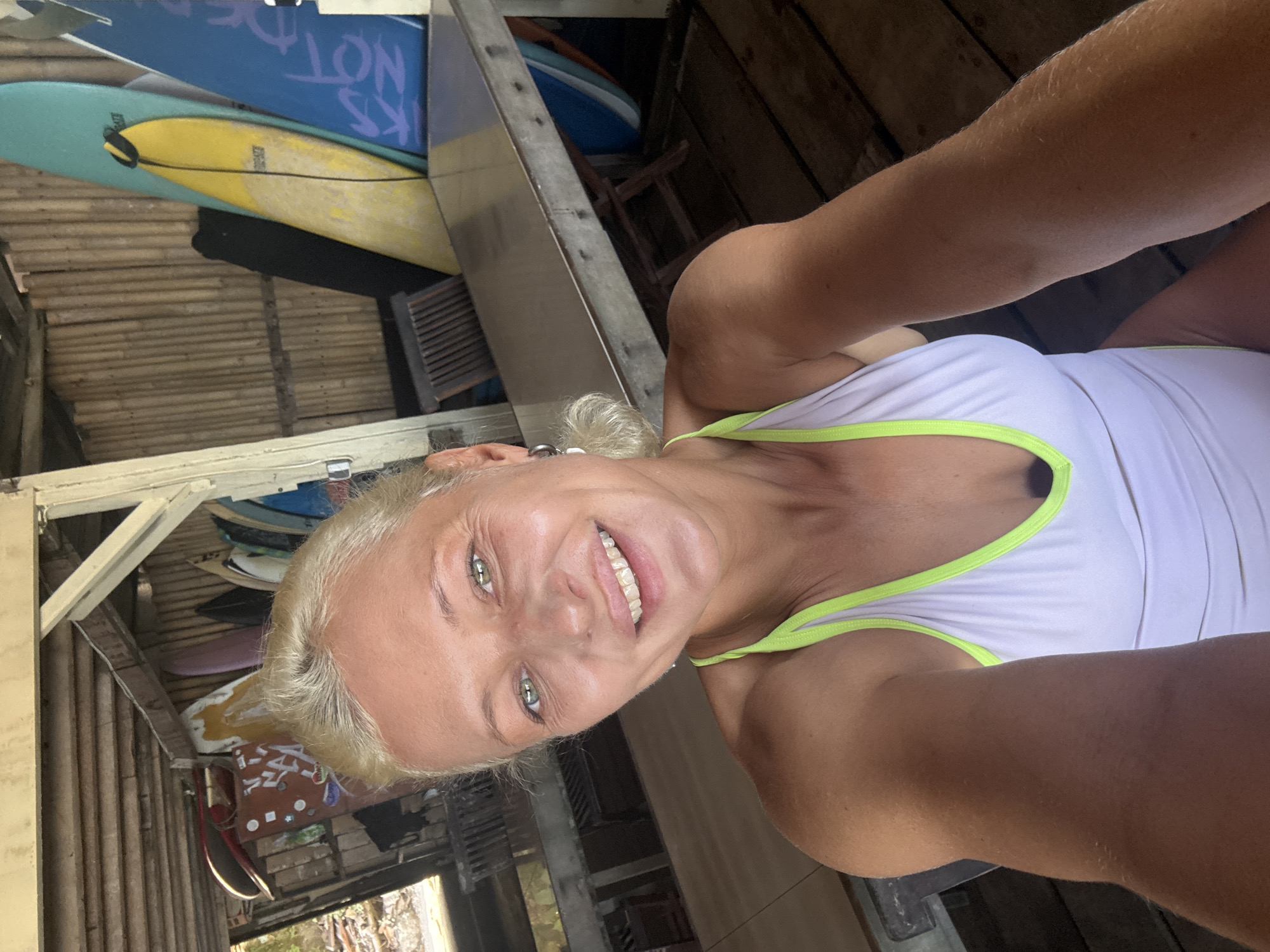 Woman takes late-night selfie at beachside cafe