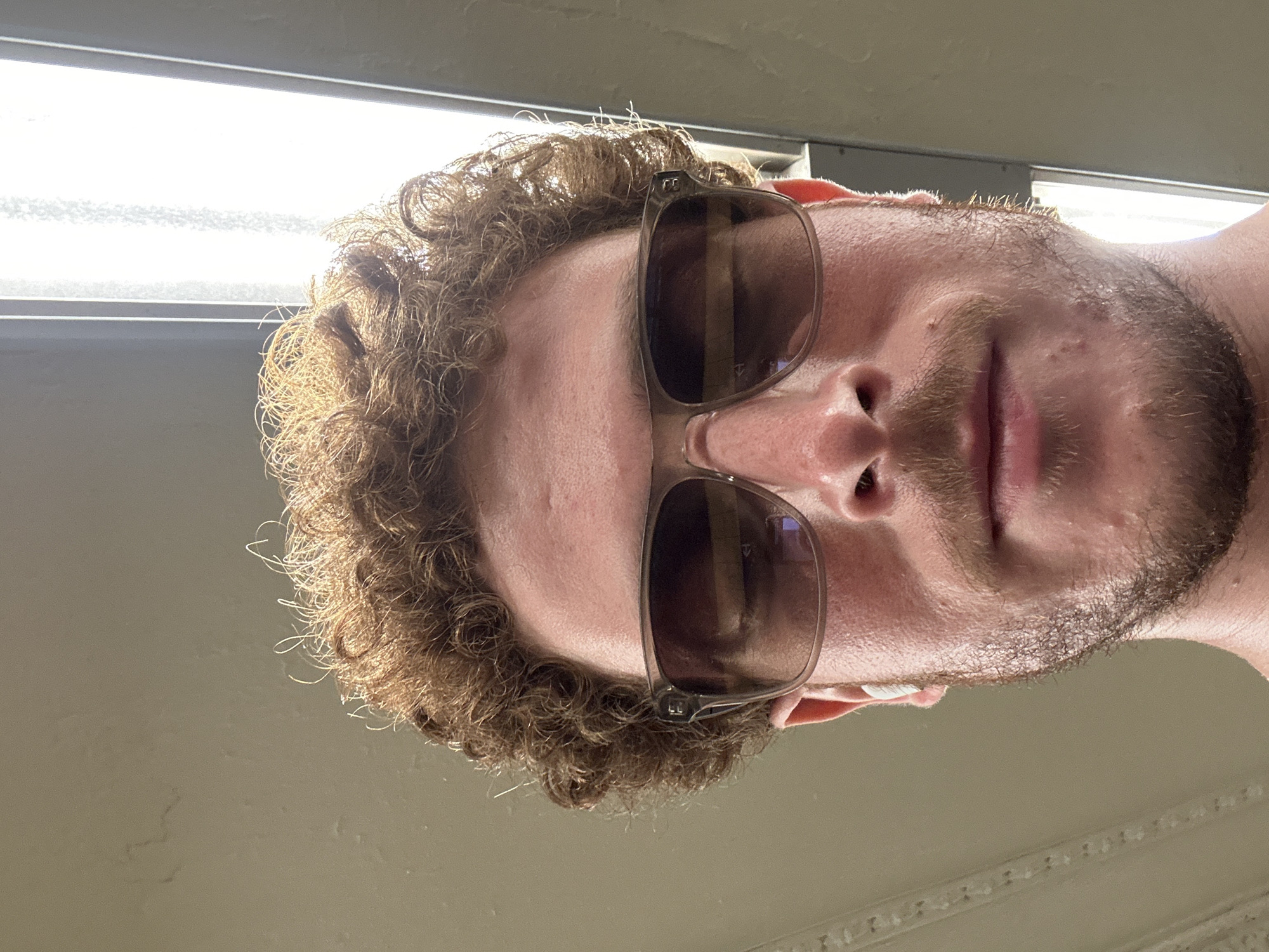 Bearded person photographed under fluorescent lights in New York