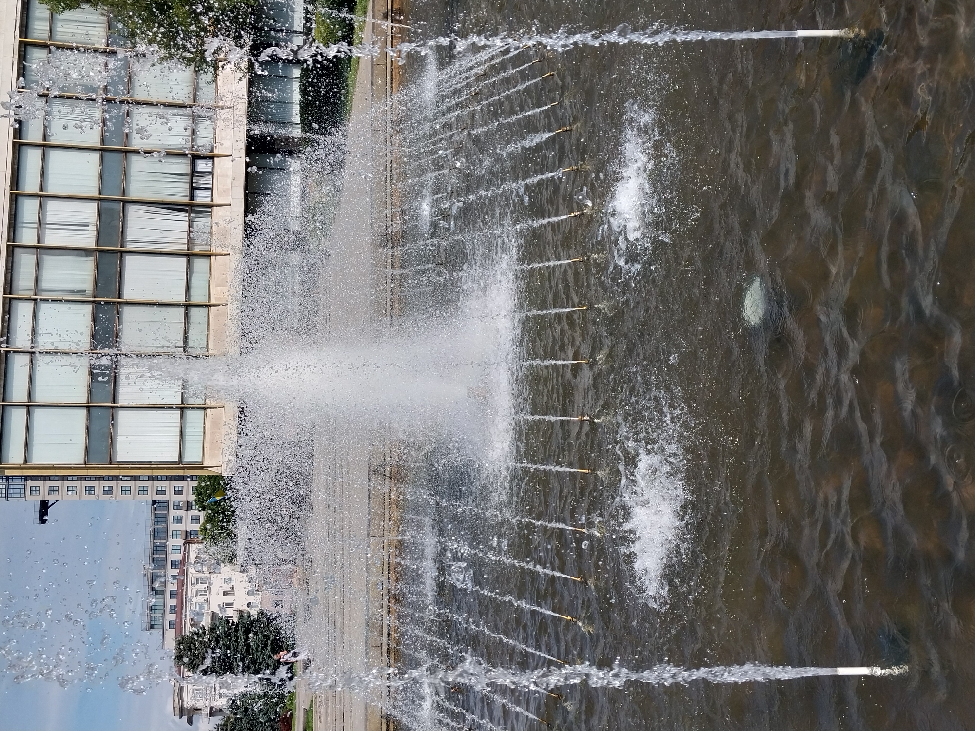 Dnipro's central fountain and plaza on a clear summer morning