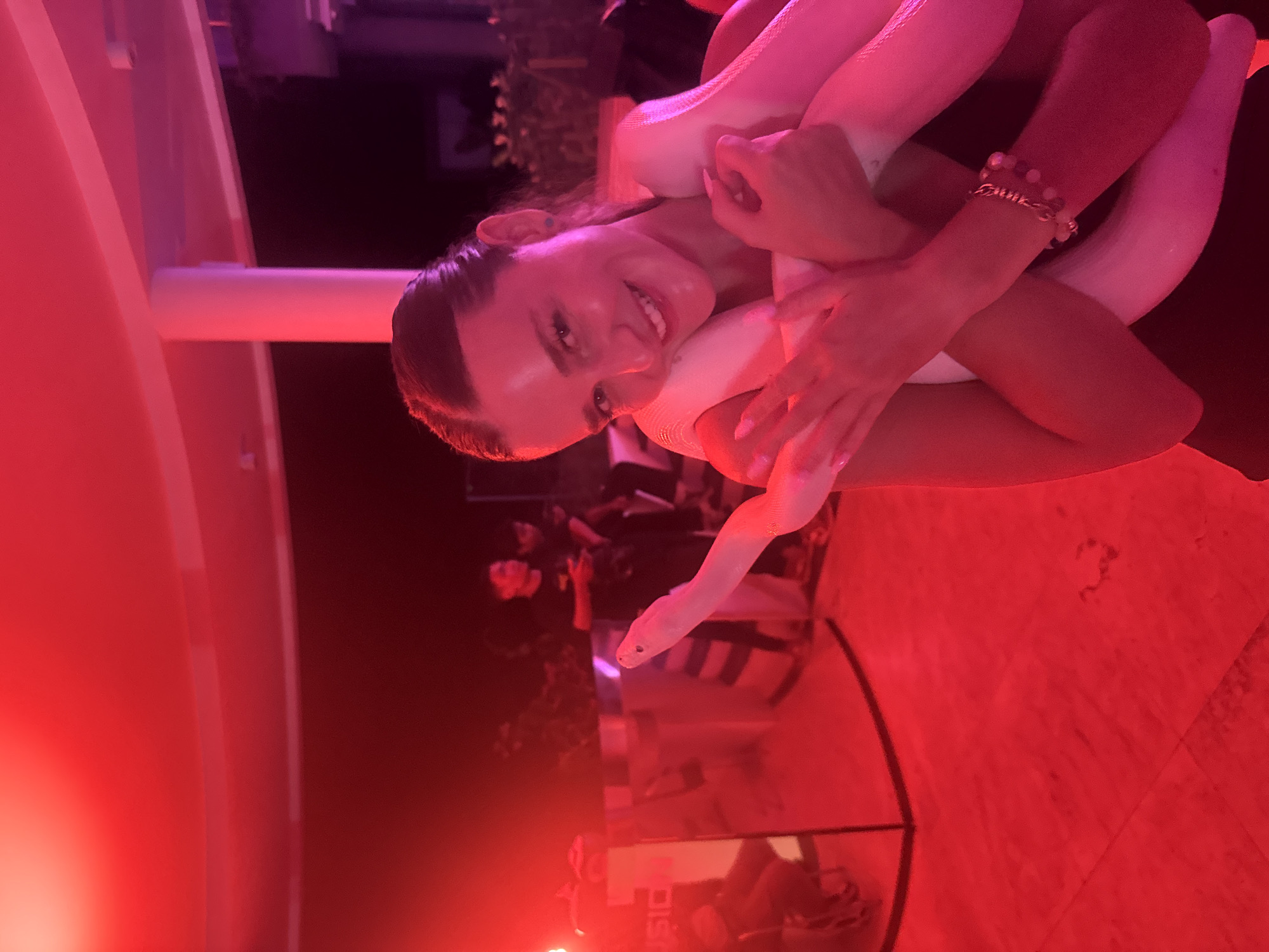 Nightlife scene captured at Bali bar with snake entertainment