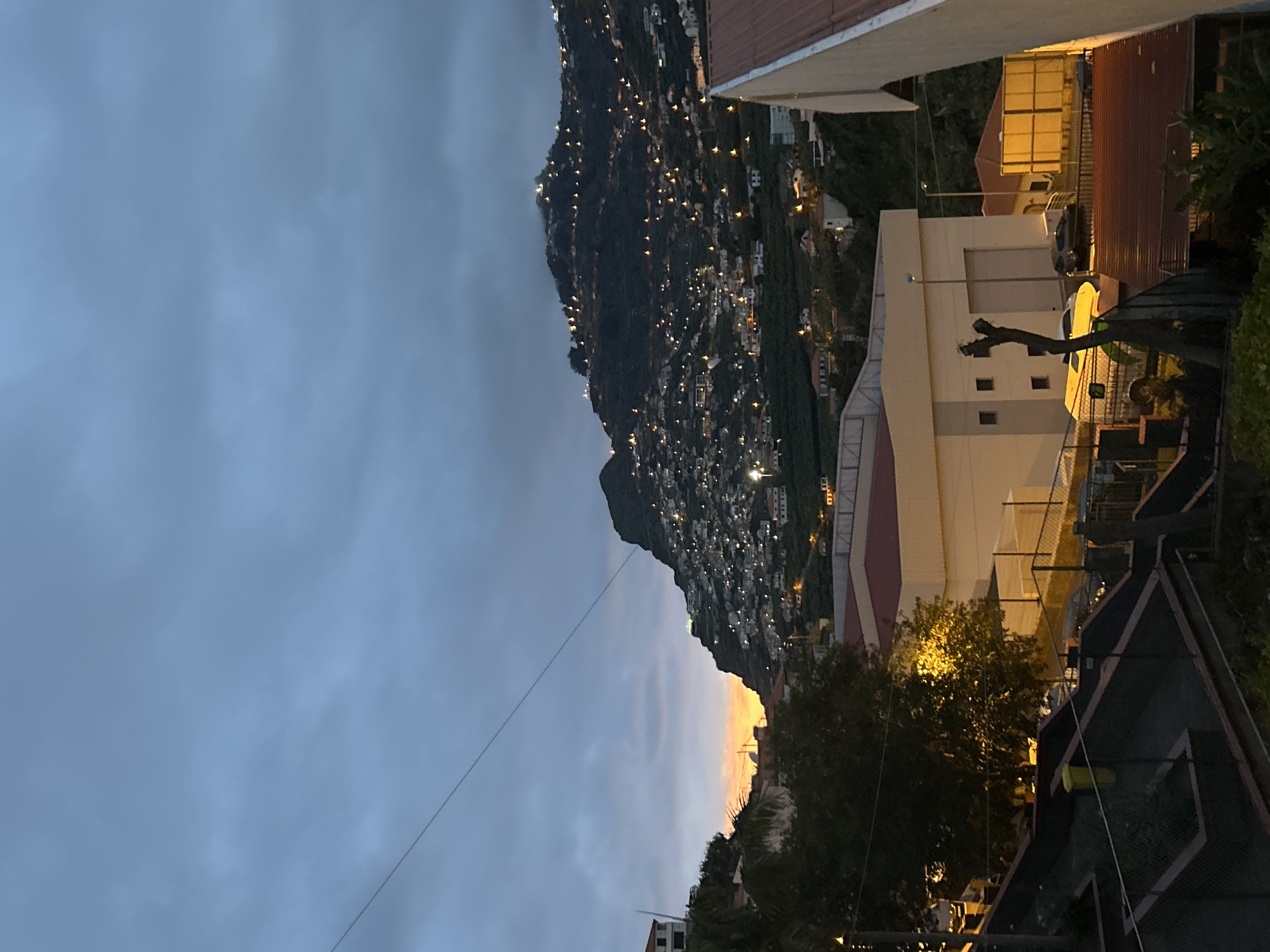 Evening lights illuminate hillside town of Câmara de Lobos