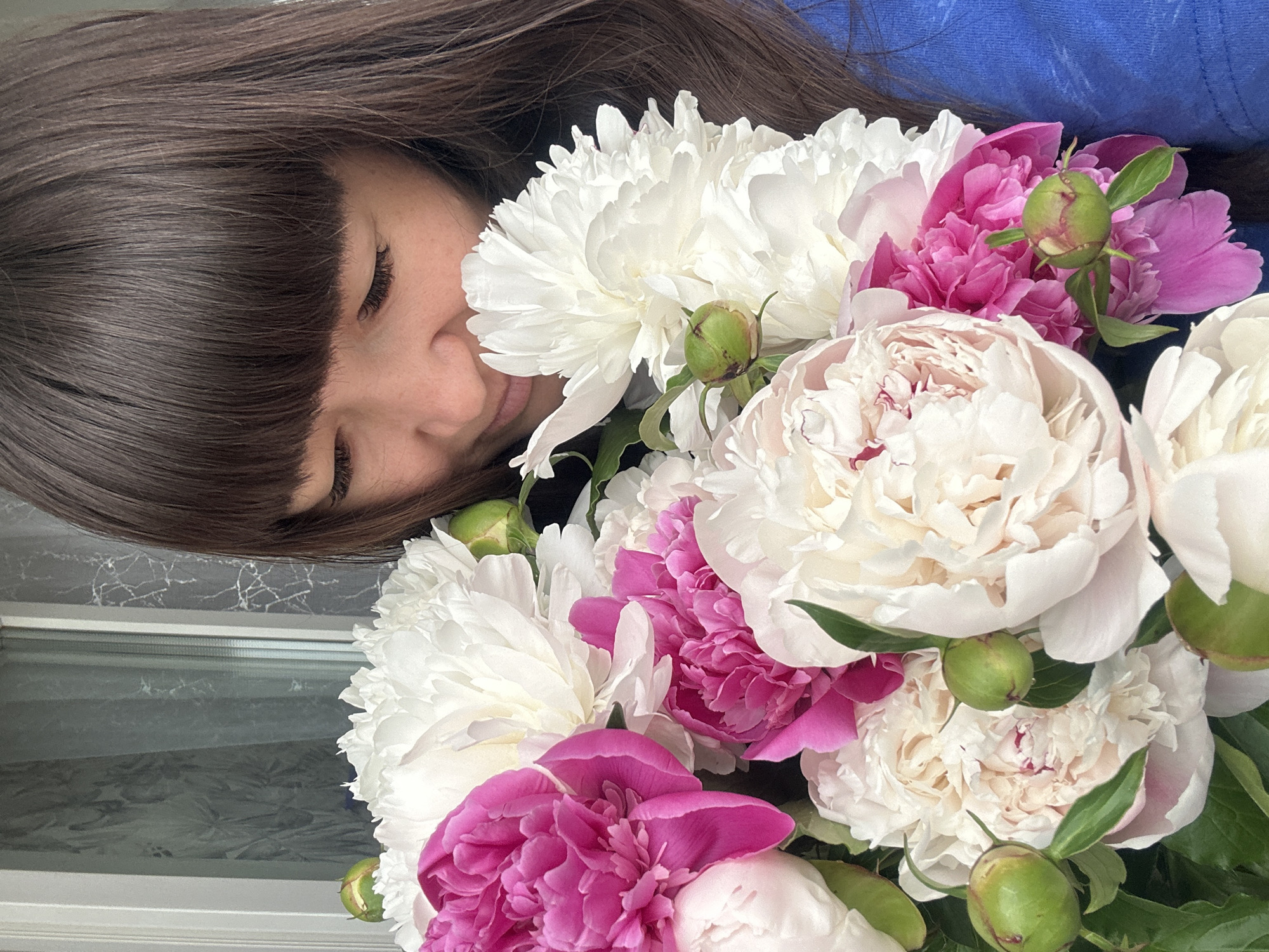 Woman poses with peony bouquet in Chaikovsky, Russia