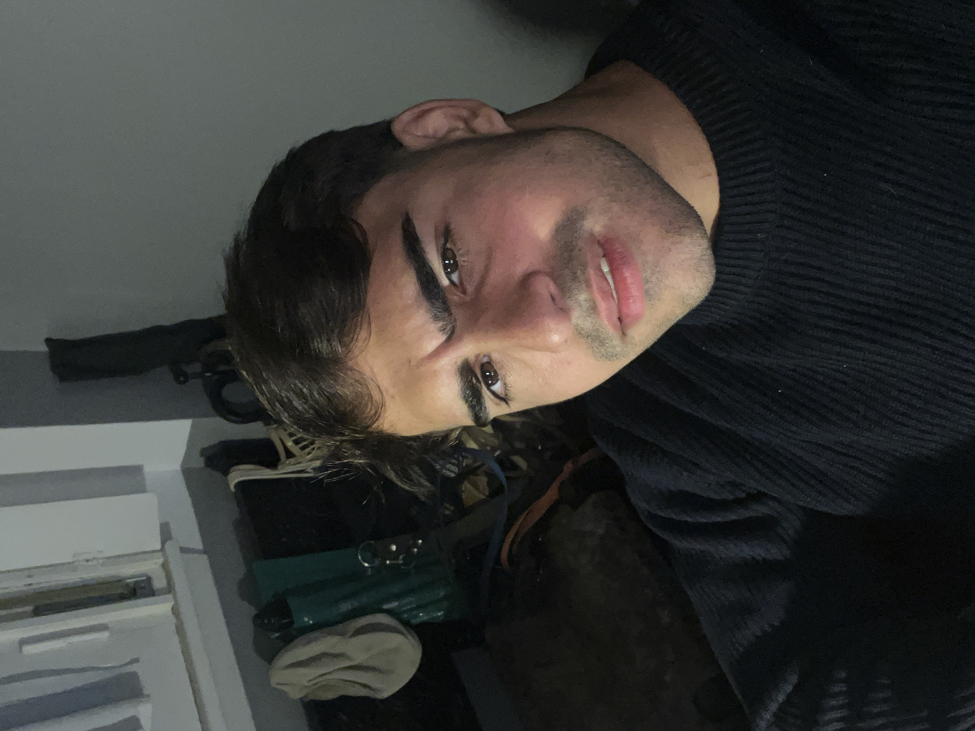 Young man takes selfies indoors in Avellaneda, Argentina